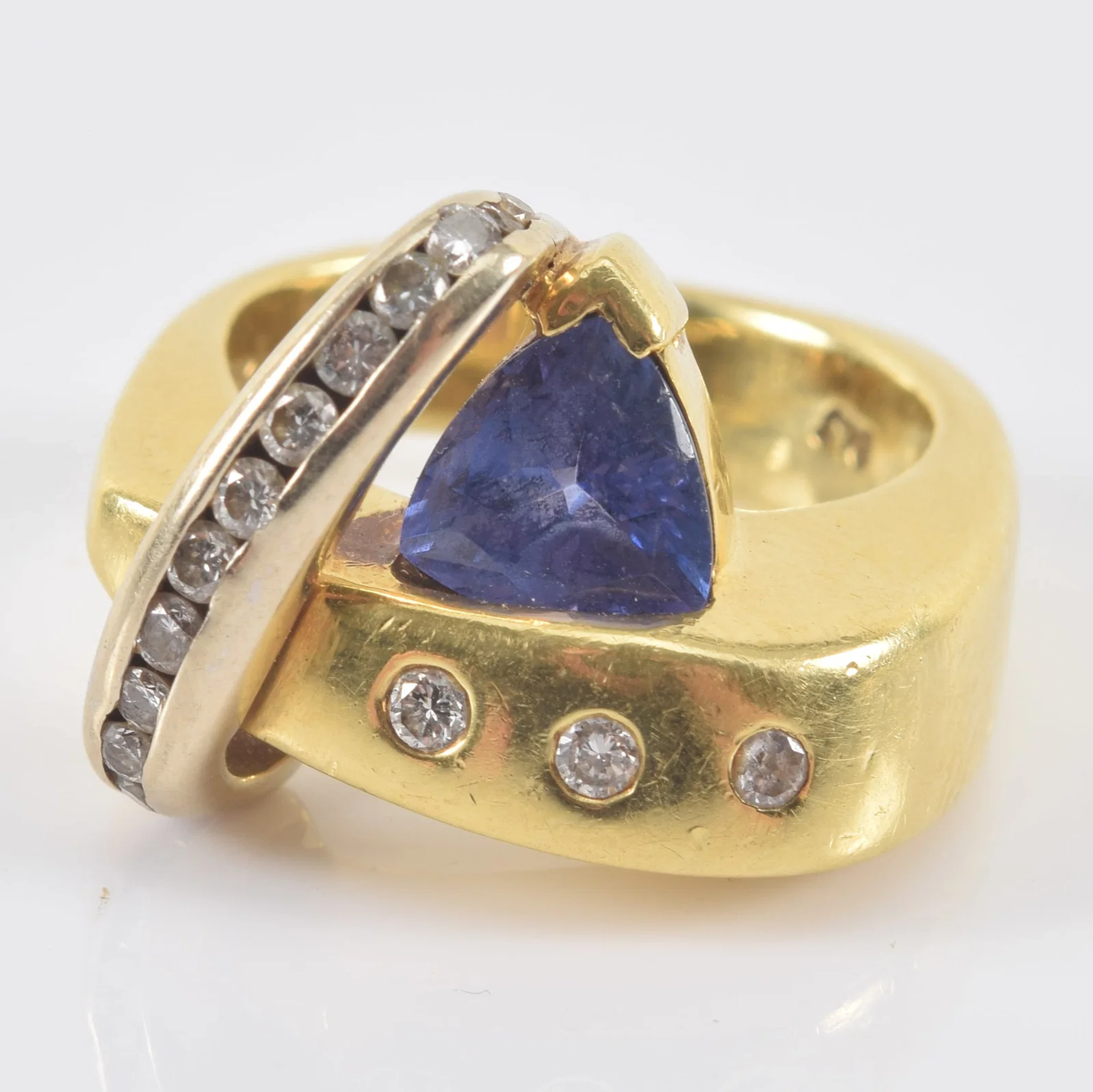 Frank Reubel 18K gold tanzanite and diamond bypass ring. Trillion