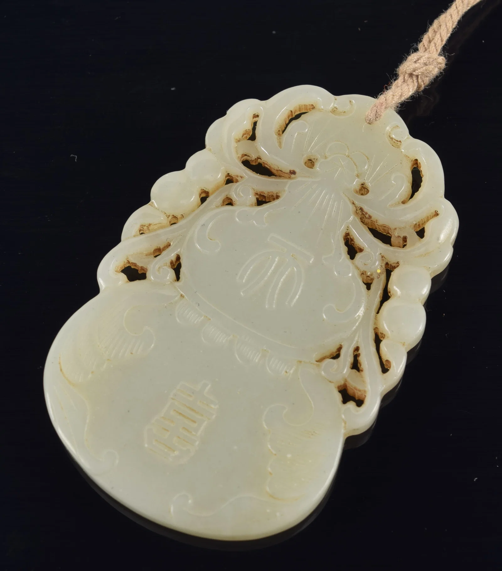 Jade pendant. China. 19th century. Double gourd form. 2.25in.