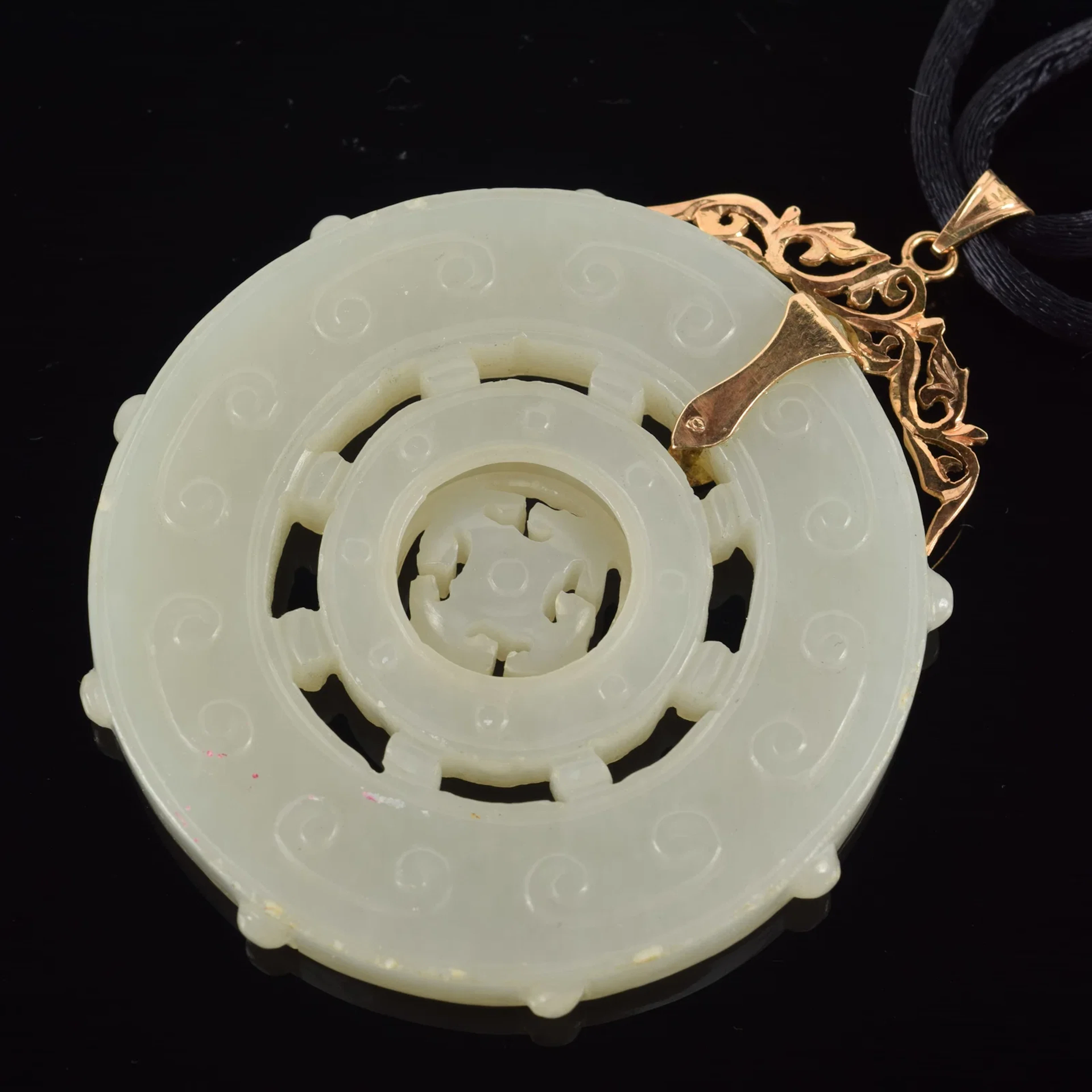 14K gold mounted Chinese celadon jade disc. Articulating center disc.
