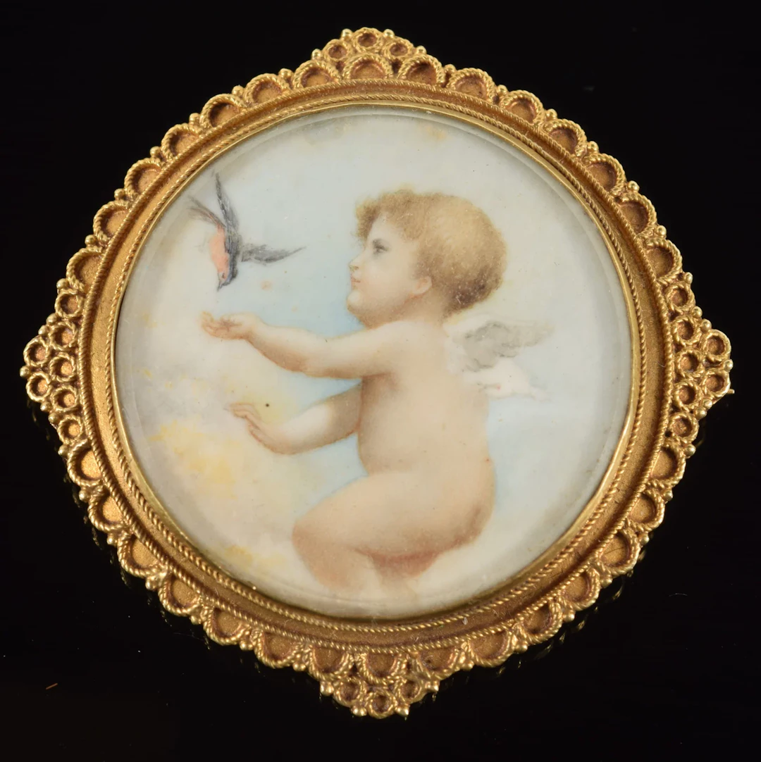 Victorian 14K gold pin with miniature painting of a cherub feeding