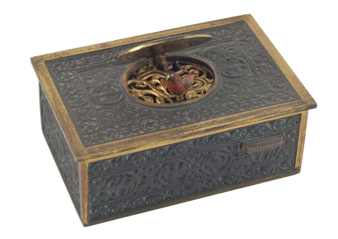 Antique singing bird automaton box. Ornate bronze case with scrolling