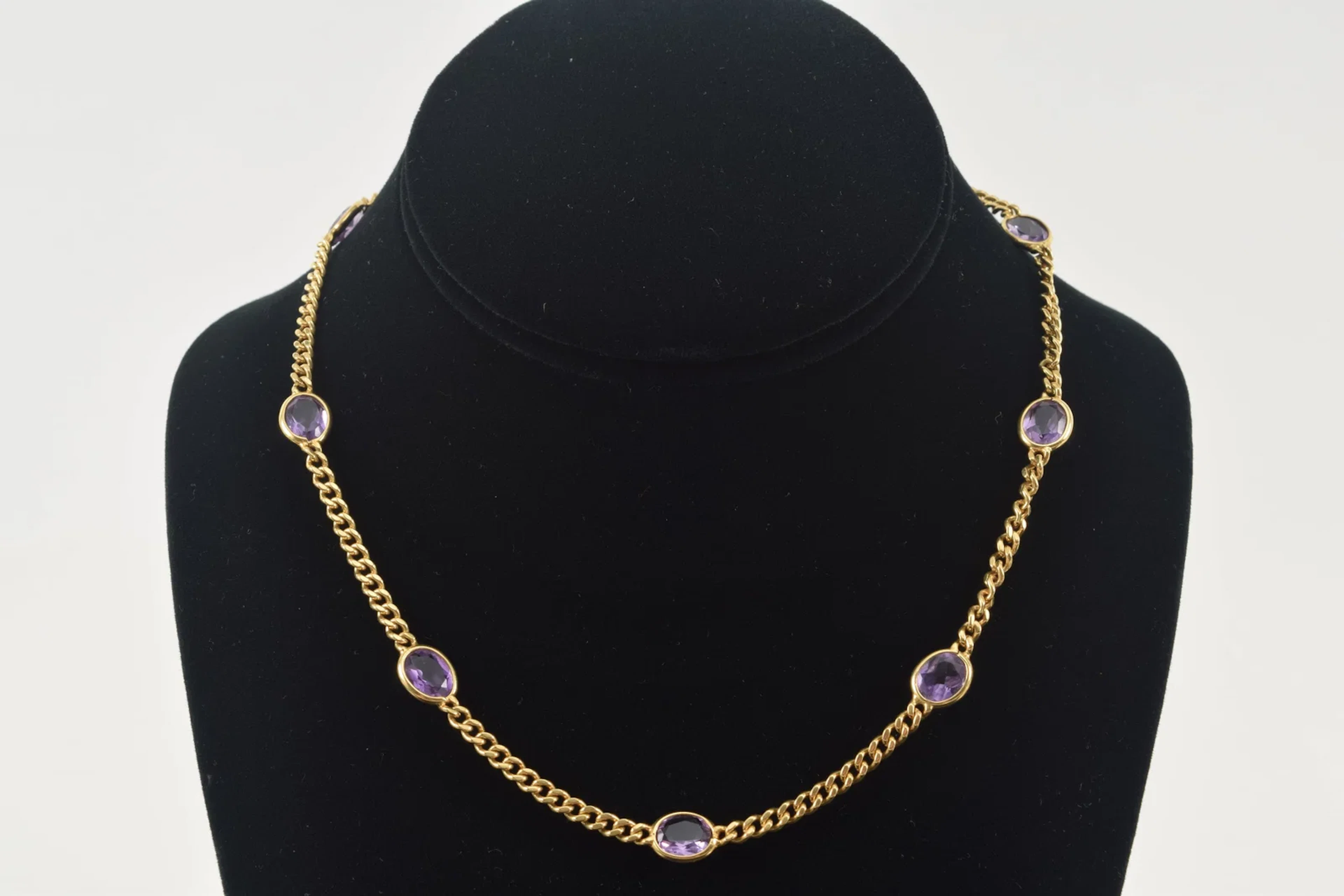 18K gold amethyst necklace. 9 oval cut amethysts, each about 7.5 x