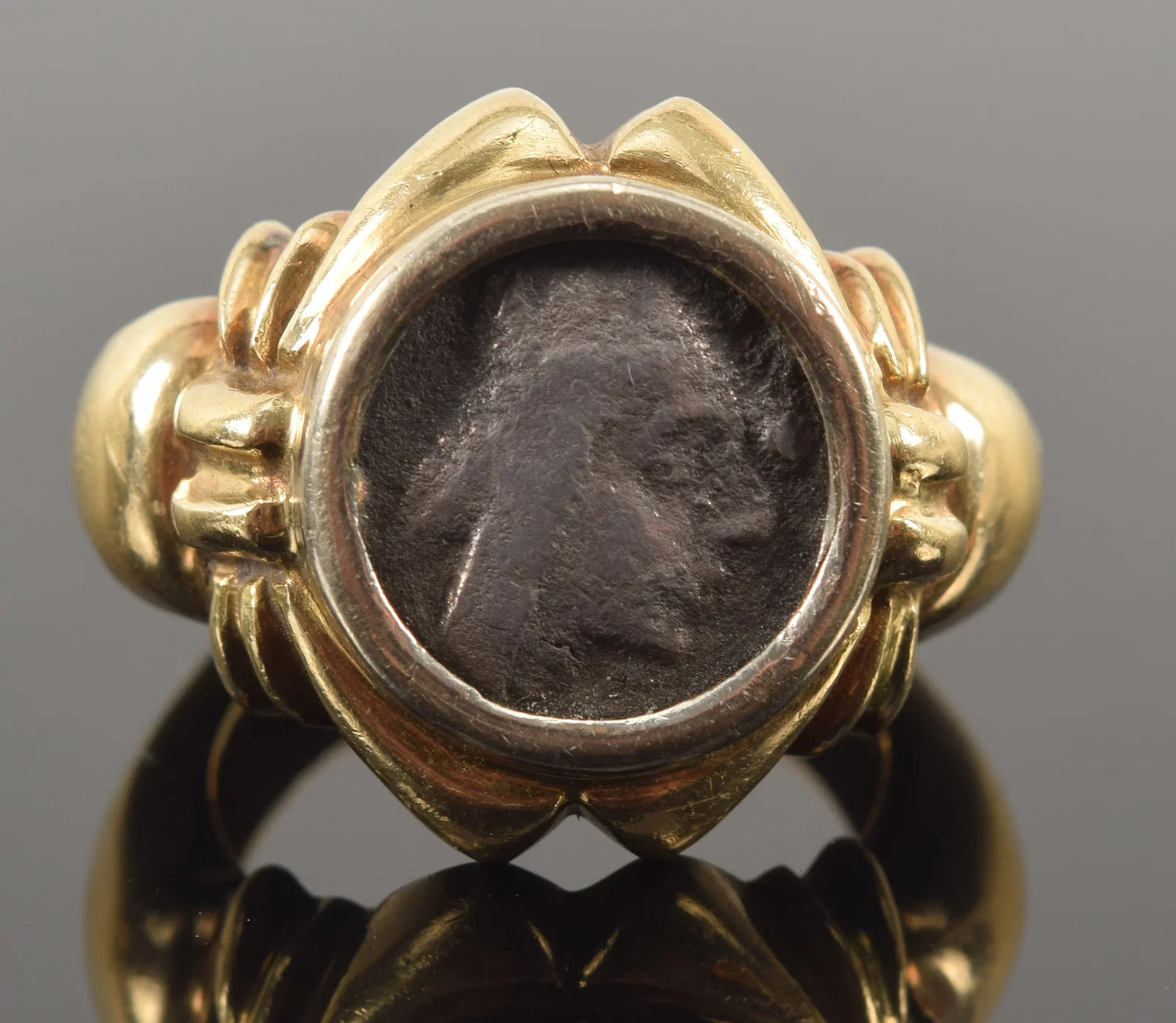 Ancient silver coin in a 14K gold ring setting. Coin measures about
