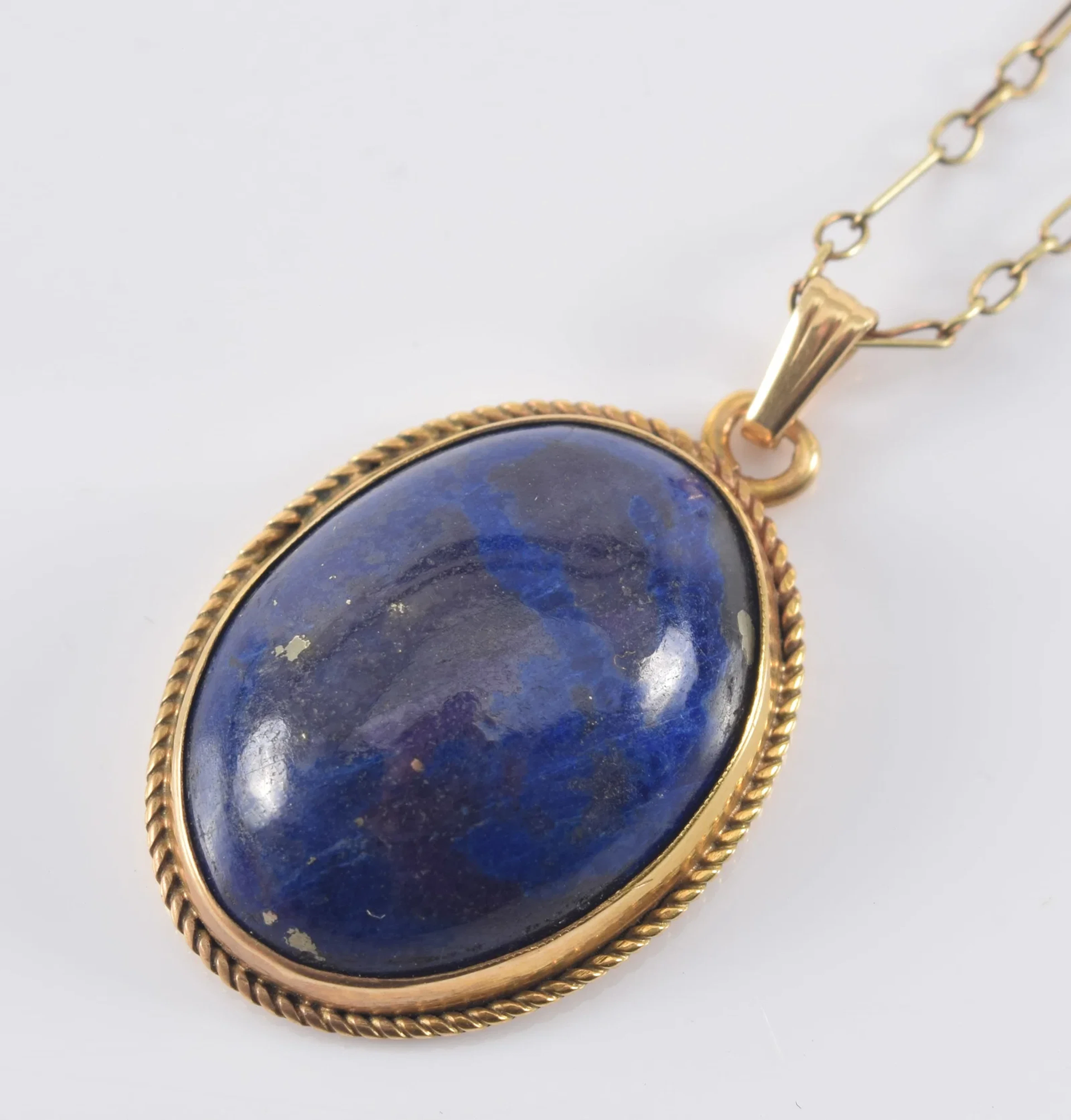 14K gold lapis lazuli pendant necklace. Large oval lapis stone in
