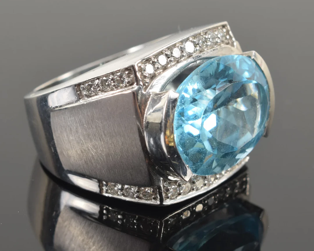 14K white gold blue topaz and diamond ring. Large oval cut topaz measuring