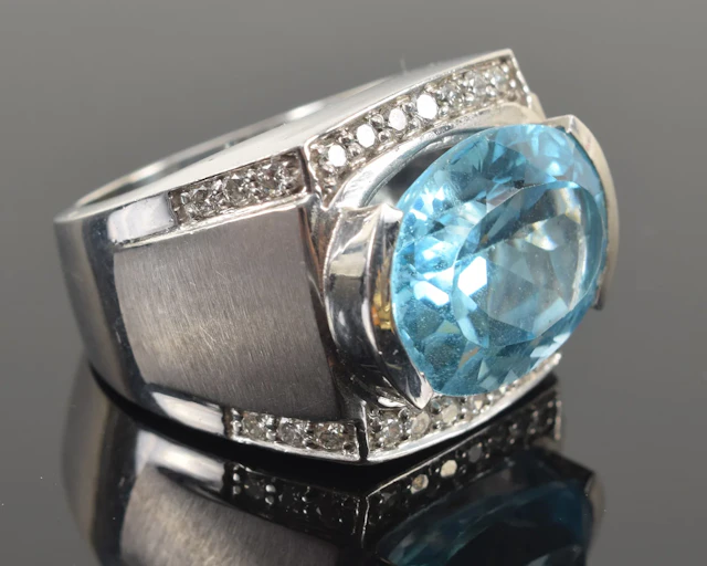 14K white gold blue topaz and diamond ring. Large oval cut topaz measuring