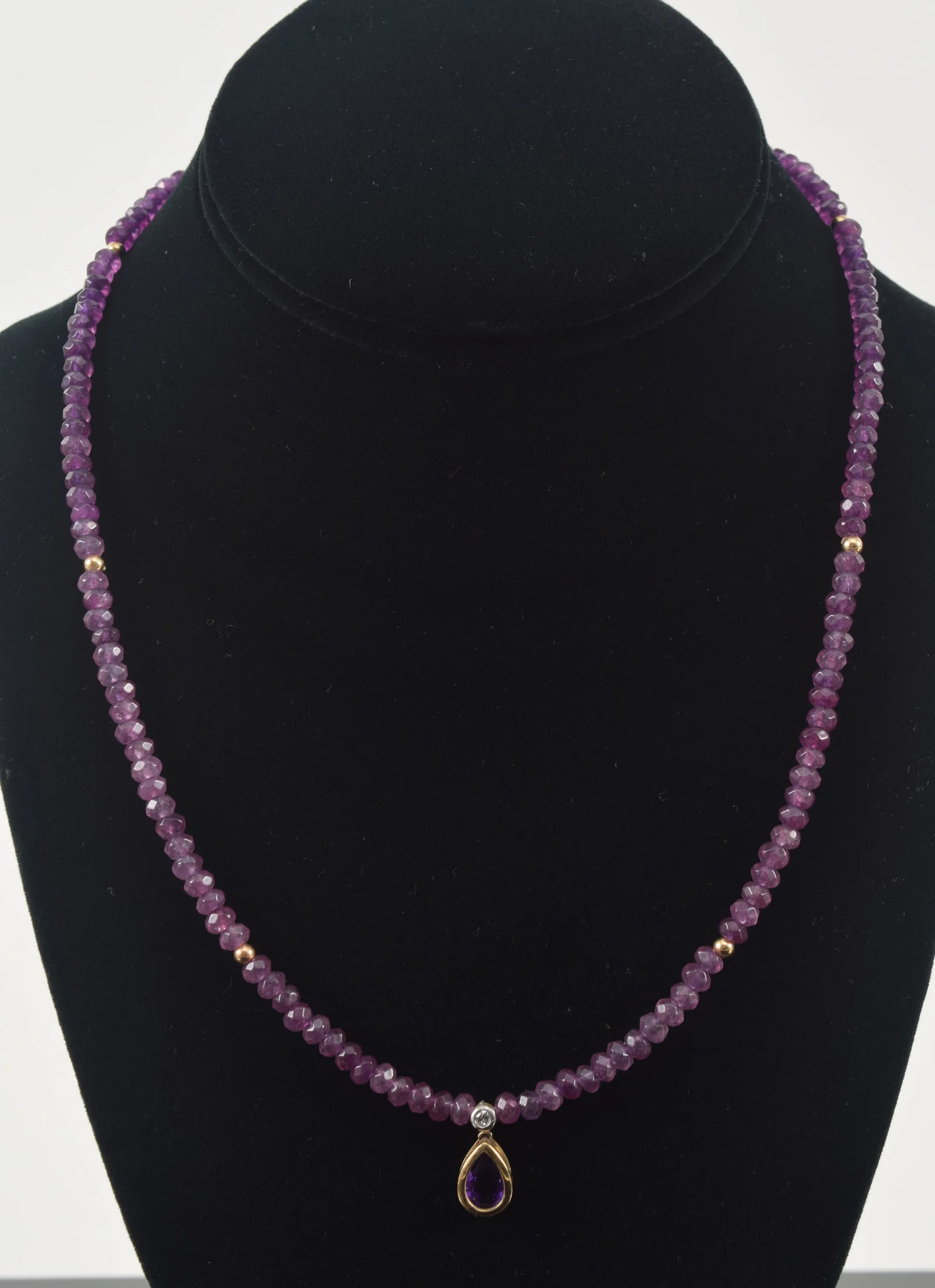 14K gold amethyst and diamond necklace. Single strand of faceted amethyst
