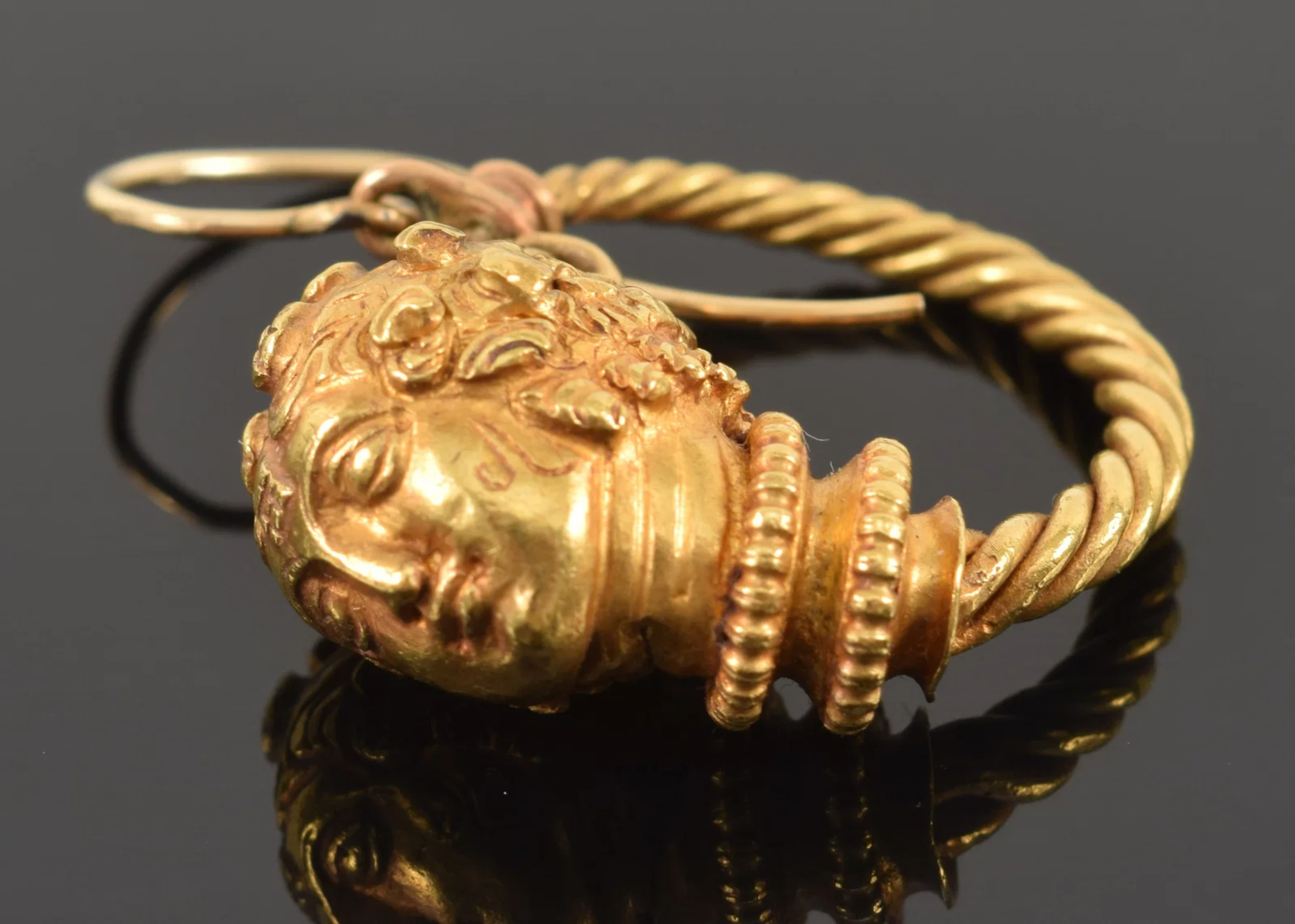 Antique gold Etruscan Revival style single earring. Braided hoop with