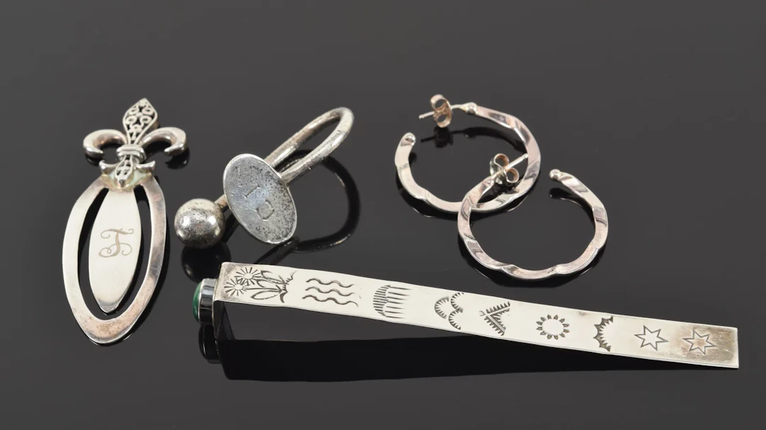 Assorted silver items. To include: Malachite mounted bookmark, fleur