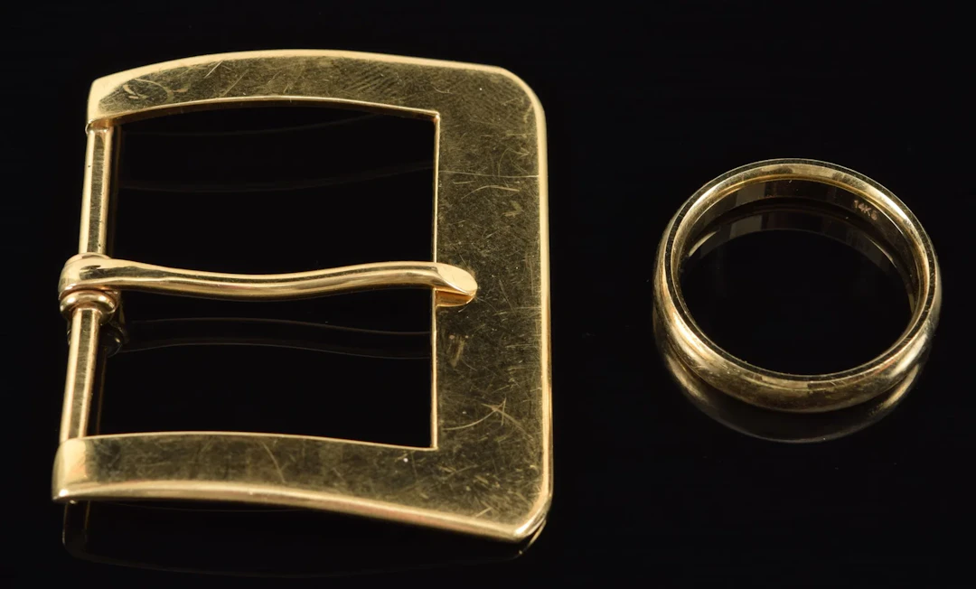 14K gold buckle and wedding band. Both marked 14K. Buckle marked "Lindsay".