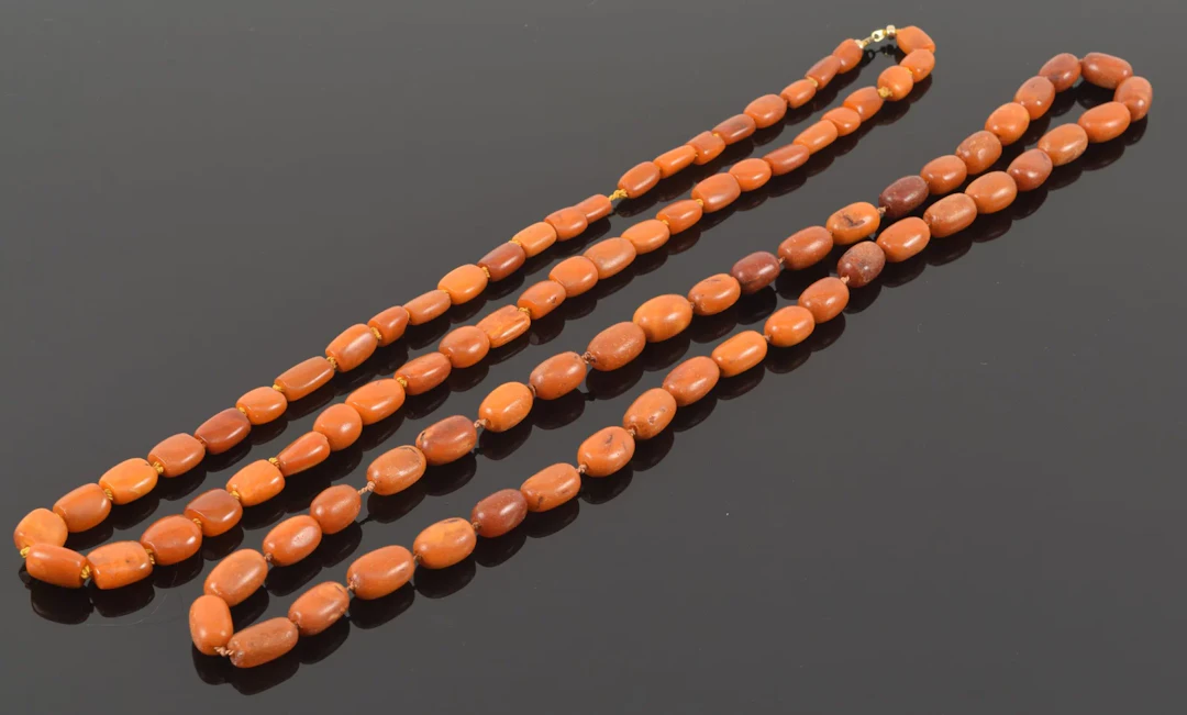 2 amber bead necklaces. 32in and 34in lengths. 53.5 grams and 74.2 grams.
