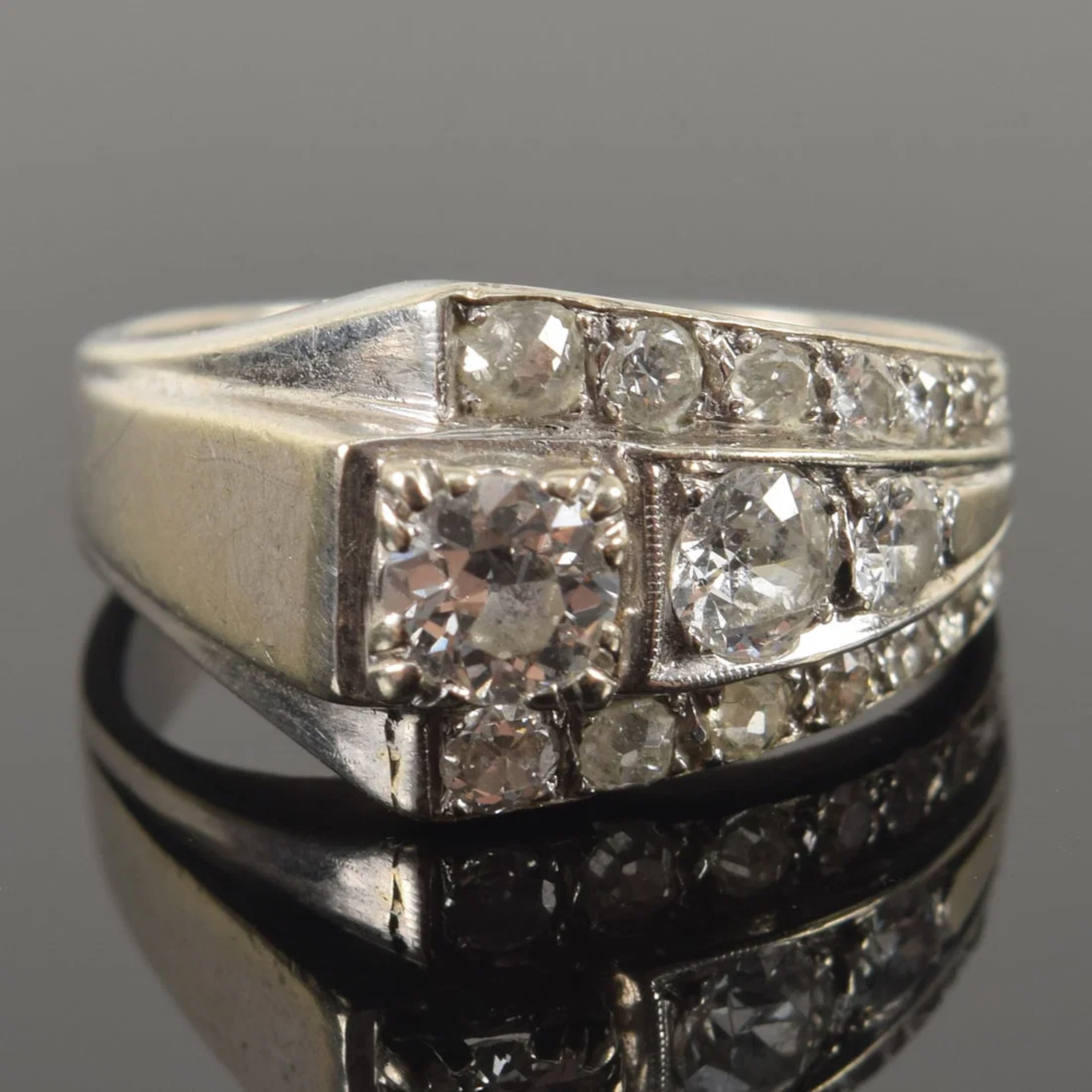 Retro 14K white gold diamond ring. 17 graduated round cut diamonds