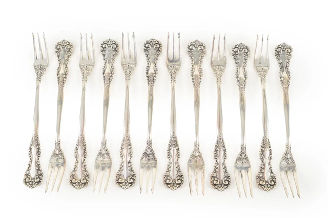 Set of 12 Sterling silver oyster forks with floral decoration. Length