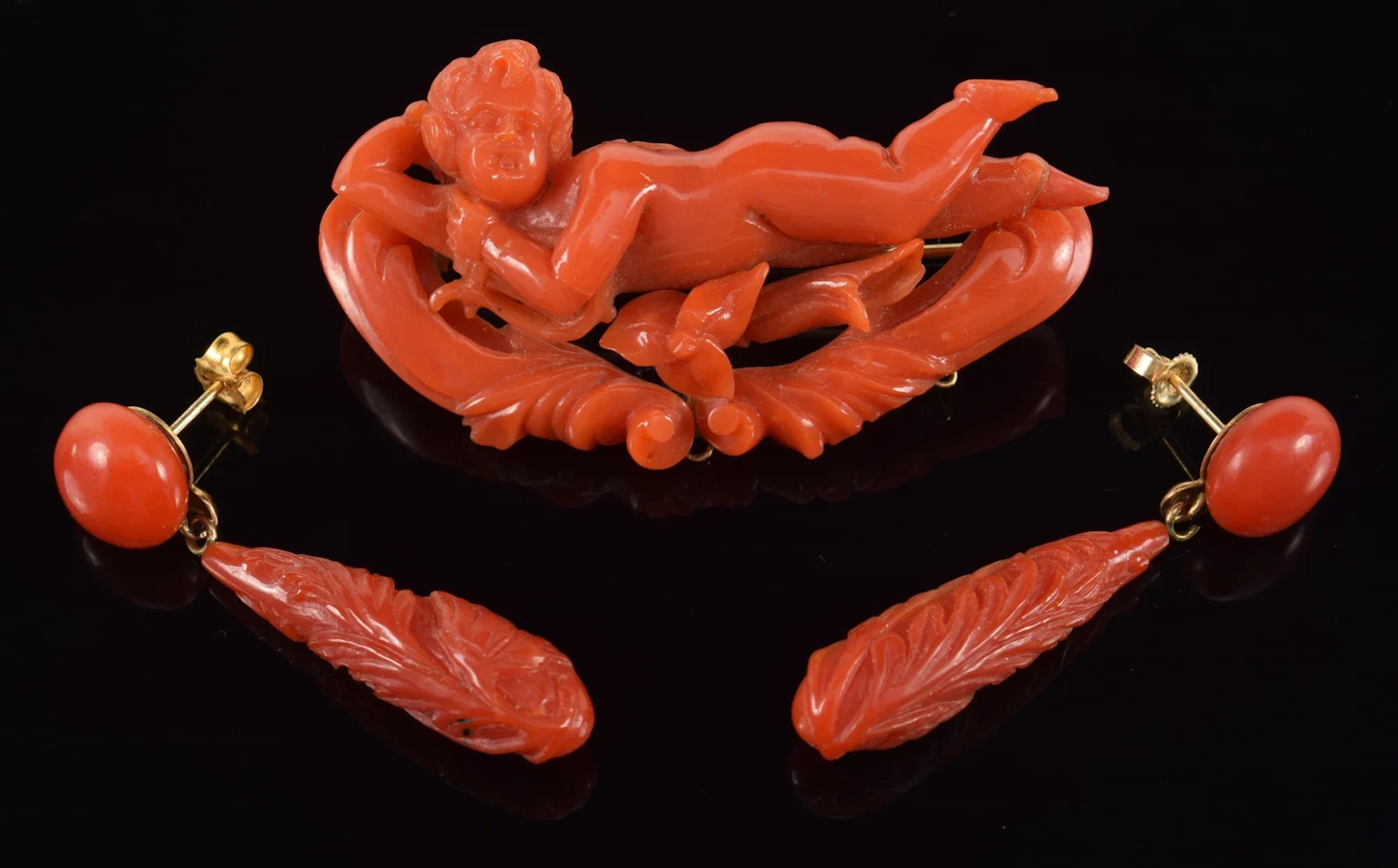 Antique gold coral jewelry. 1) Carved putti pin with 14K gold mounts.