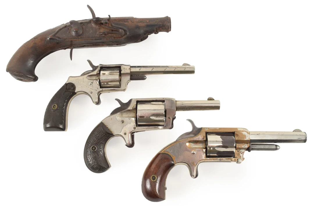 Lot of 4 antique pistols. To include: 1) Flintlock pistol relic with