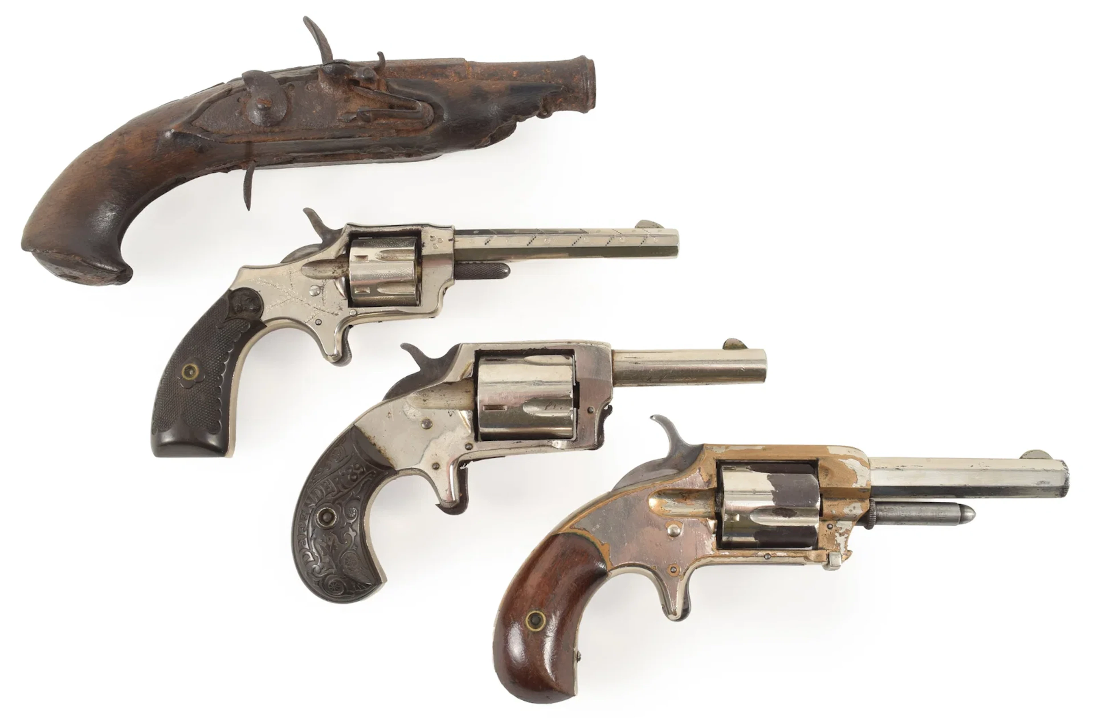 Lot of 4 antique pistols. To include: 1) Flintlock pistol relic with