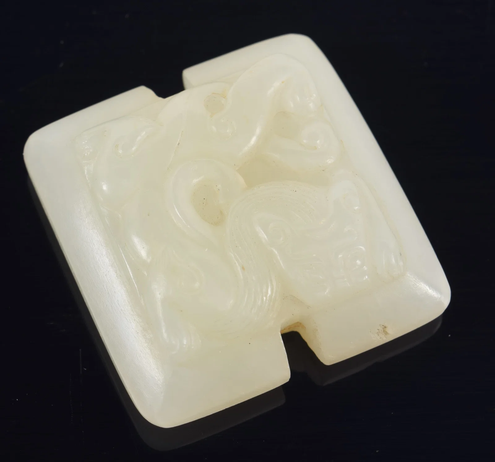 Jade pendant. China. 18th century. Surface carved with chih lung. 1.5in.