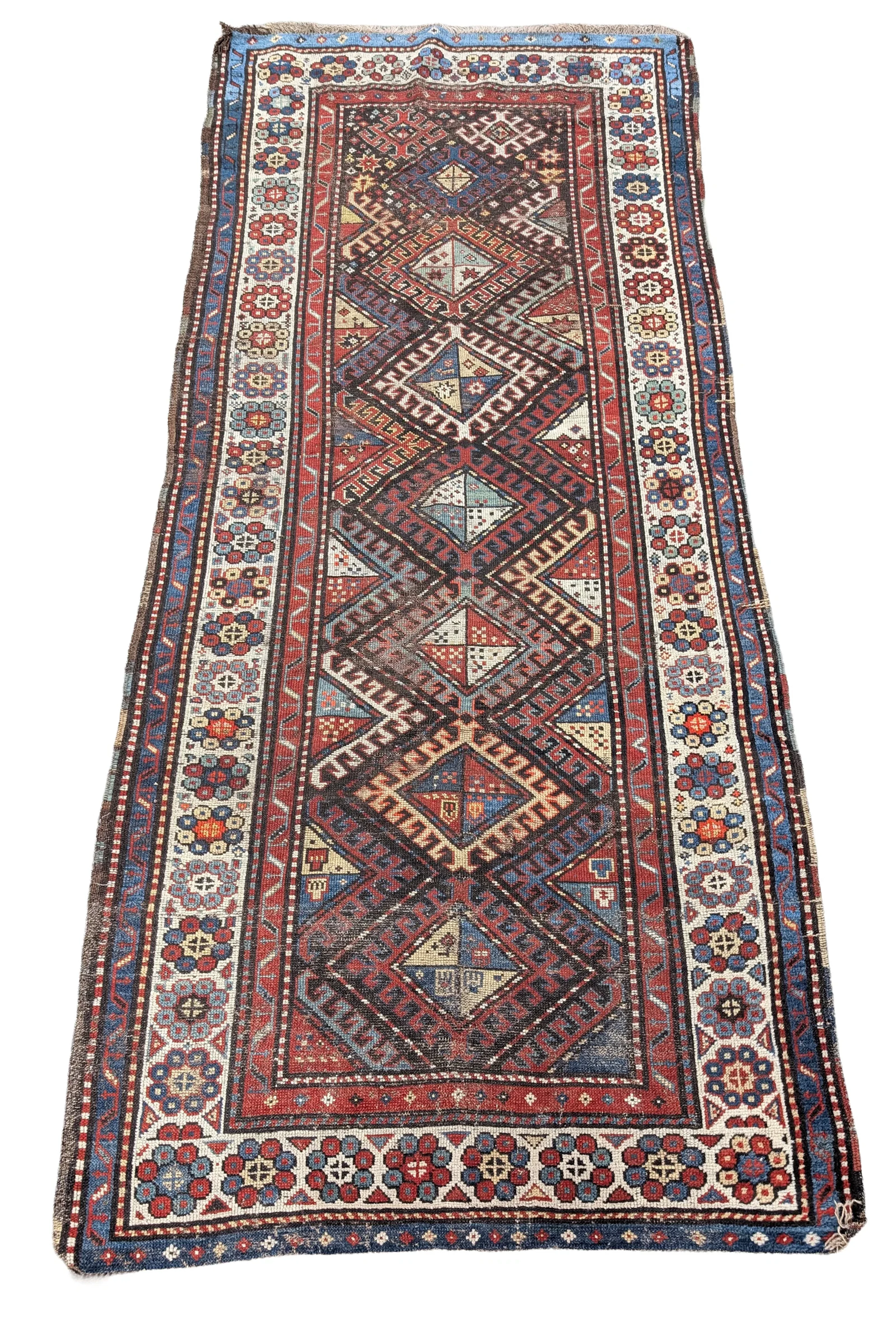 Caucasian rug, early 20th century. Some areas of wear. 104 x 44.5in.