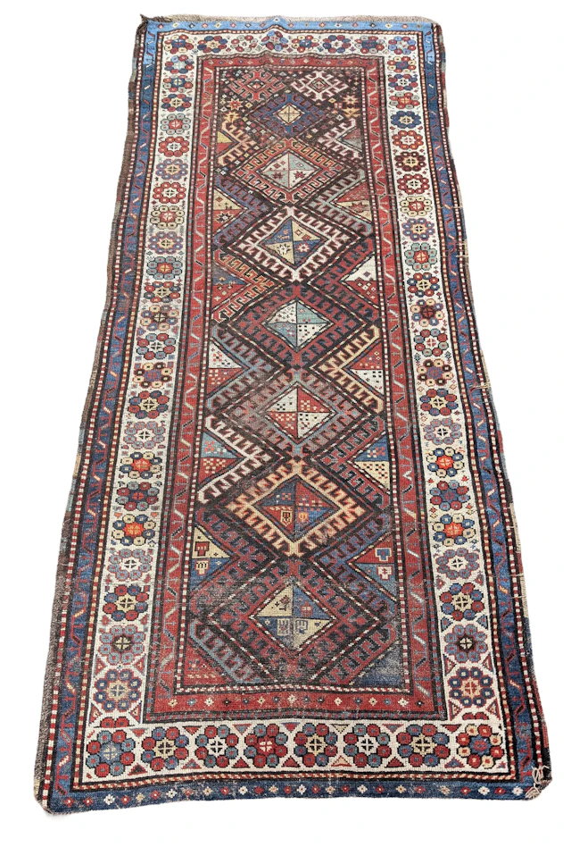Caucasian rug, early 20th century. Some areas of wear. 104 x 44.5in.