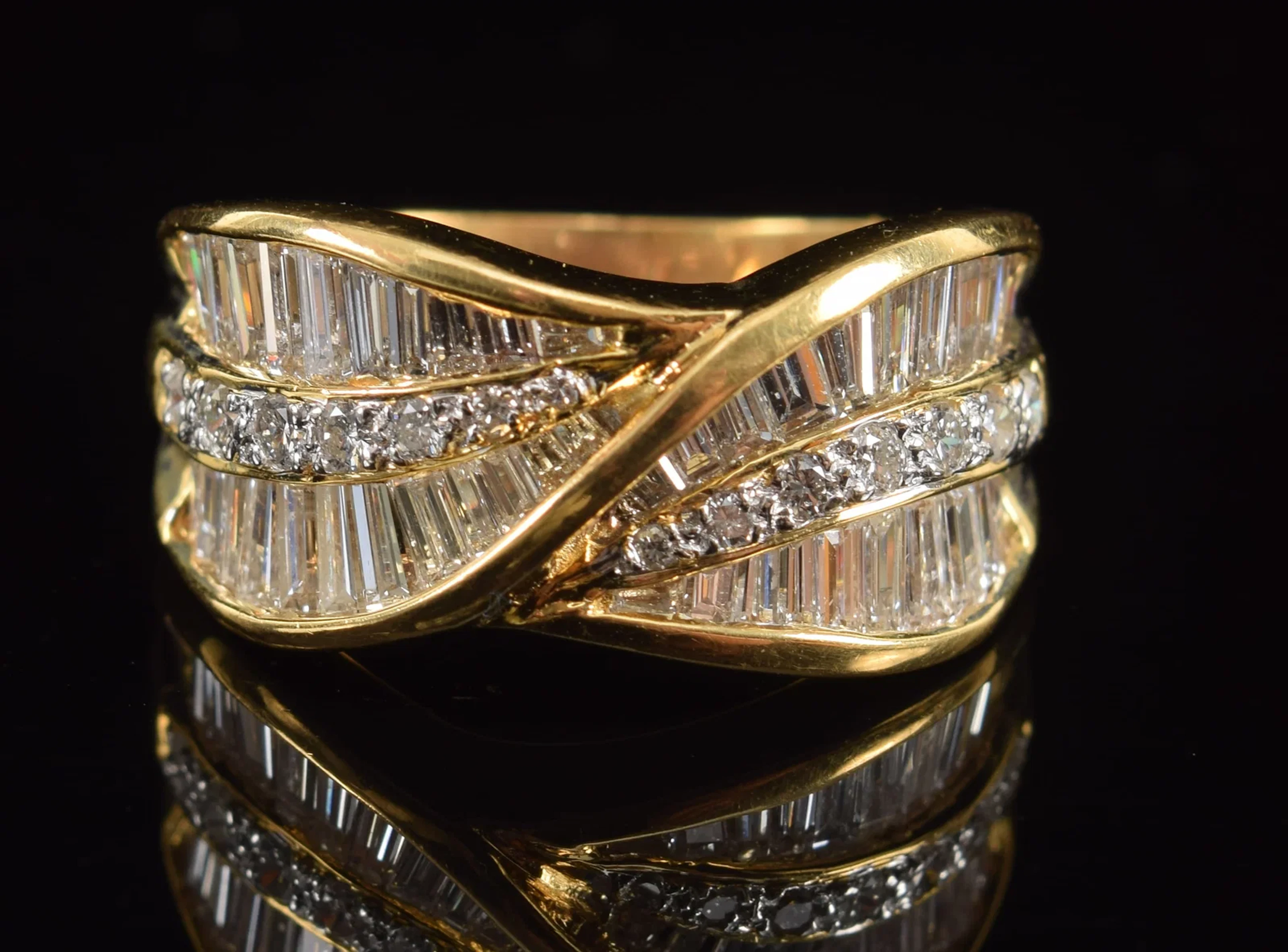 18K gold diamond ring. Leaf form sections of 3 channels of diamonds