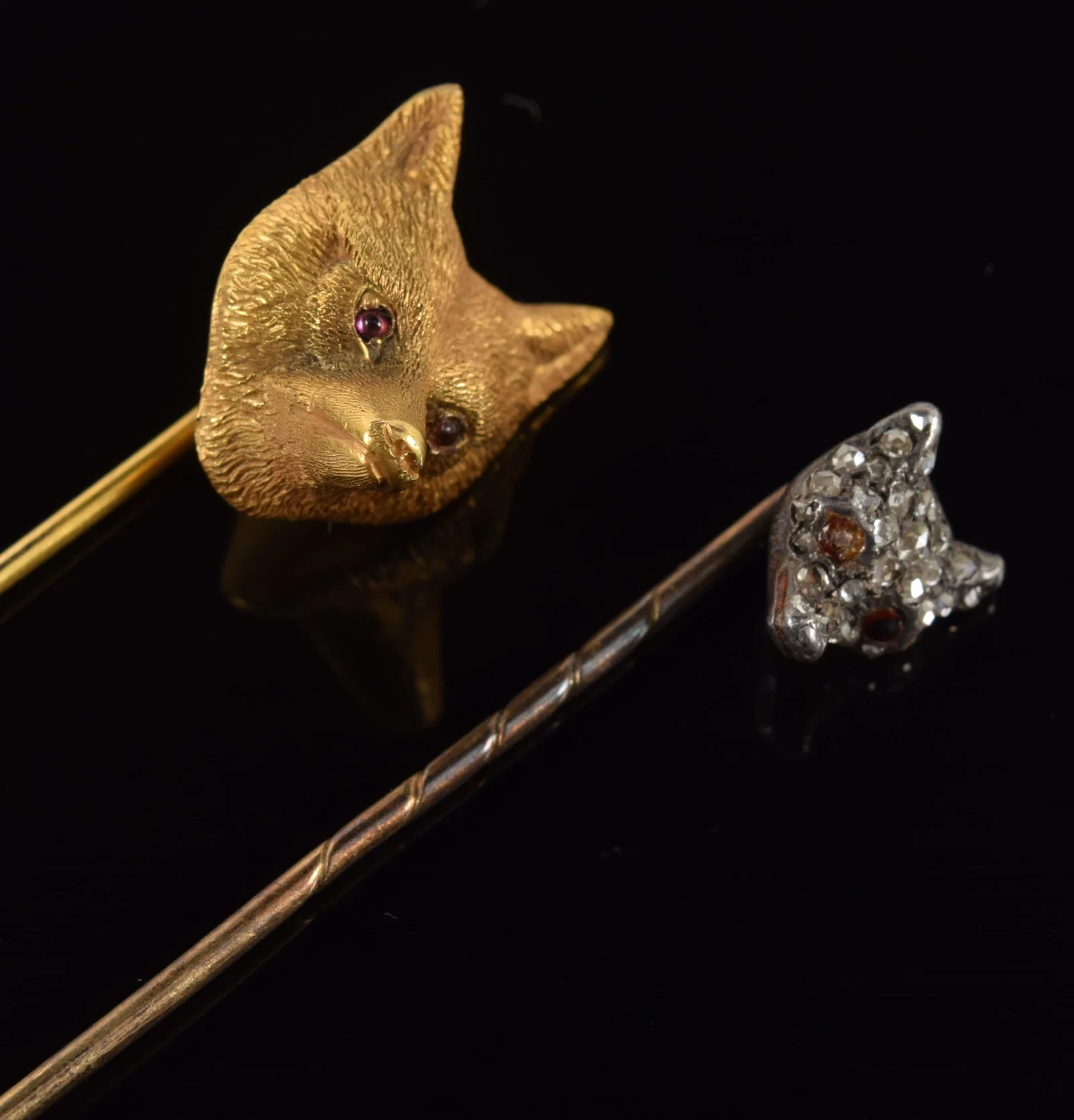 2 antique gold fox head stick pins. 1) 14K gold pin with fine detail