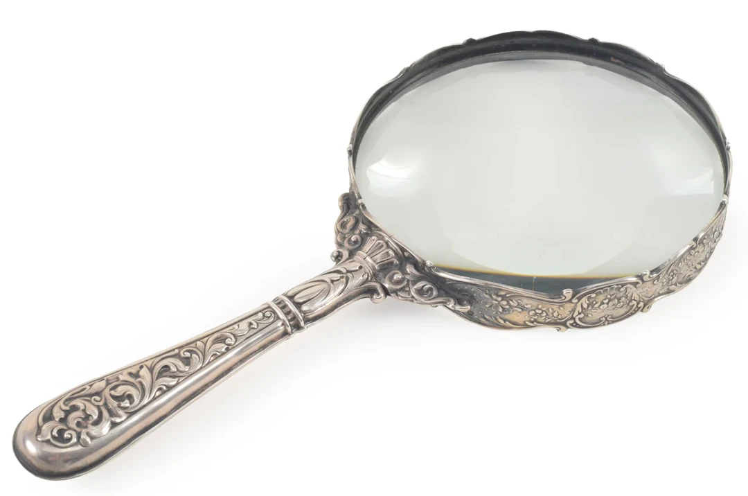 Large Gorham Sterling silver magnifying glass with floral decoration.