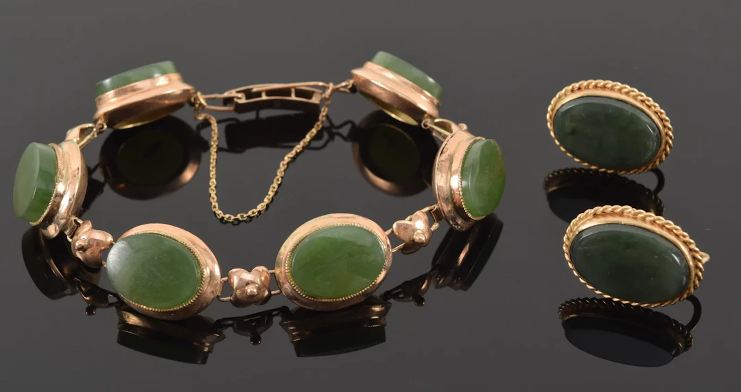 Gold green nephrite jewelry. To include: 1) 14K bracelet set with