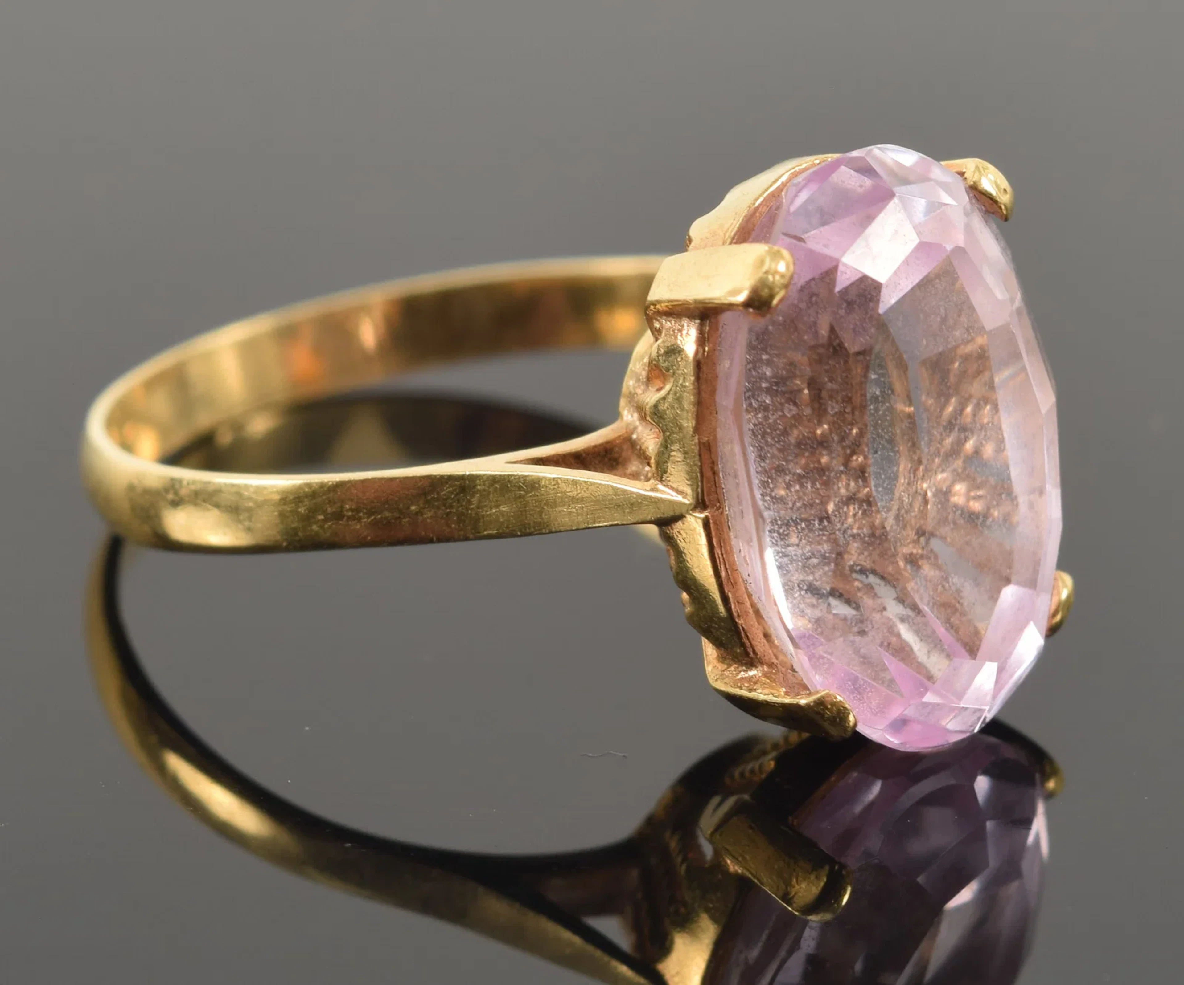 18K gold pink sapphire ring. Oval cut sapphire measures 14 x 10mm.