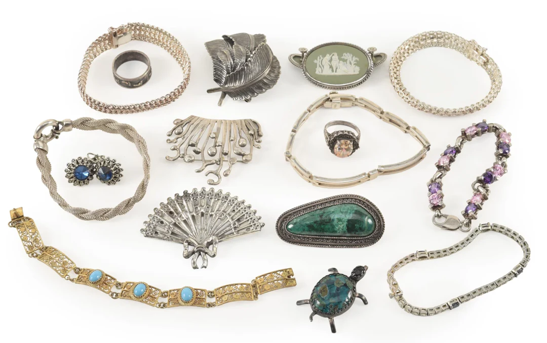 Assortment of silver jewelry. To include: Wedgwood pin and earrings