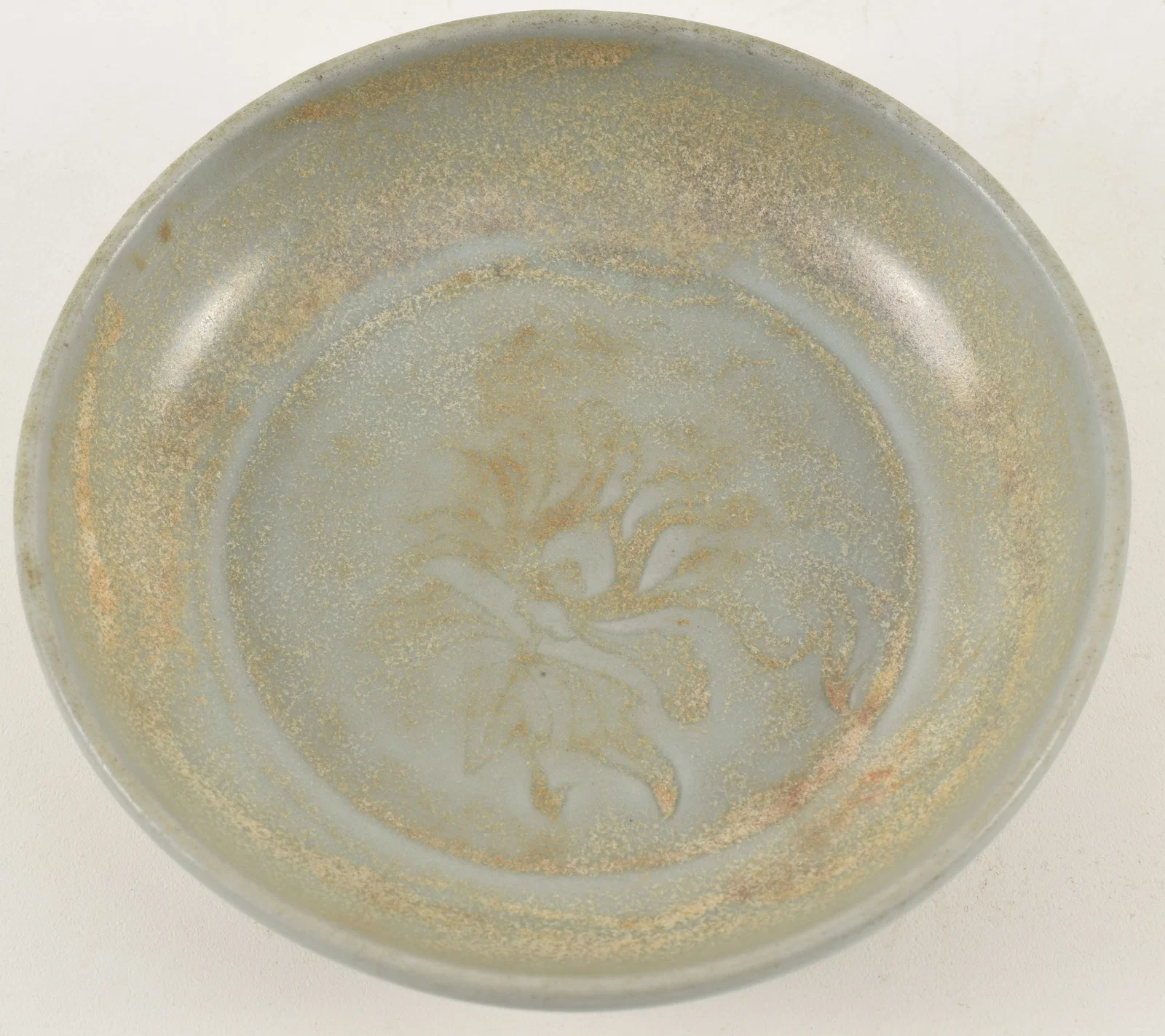 Early Chinese celadon dish with floral decoration, possibly Guan ware.