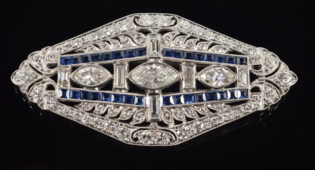 Art Deco 18K white gold diamond and sapphire brooch. Center set with