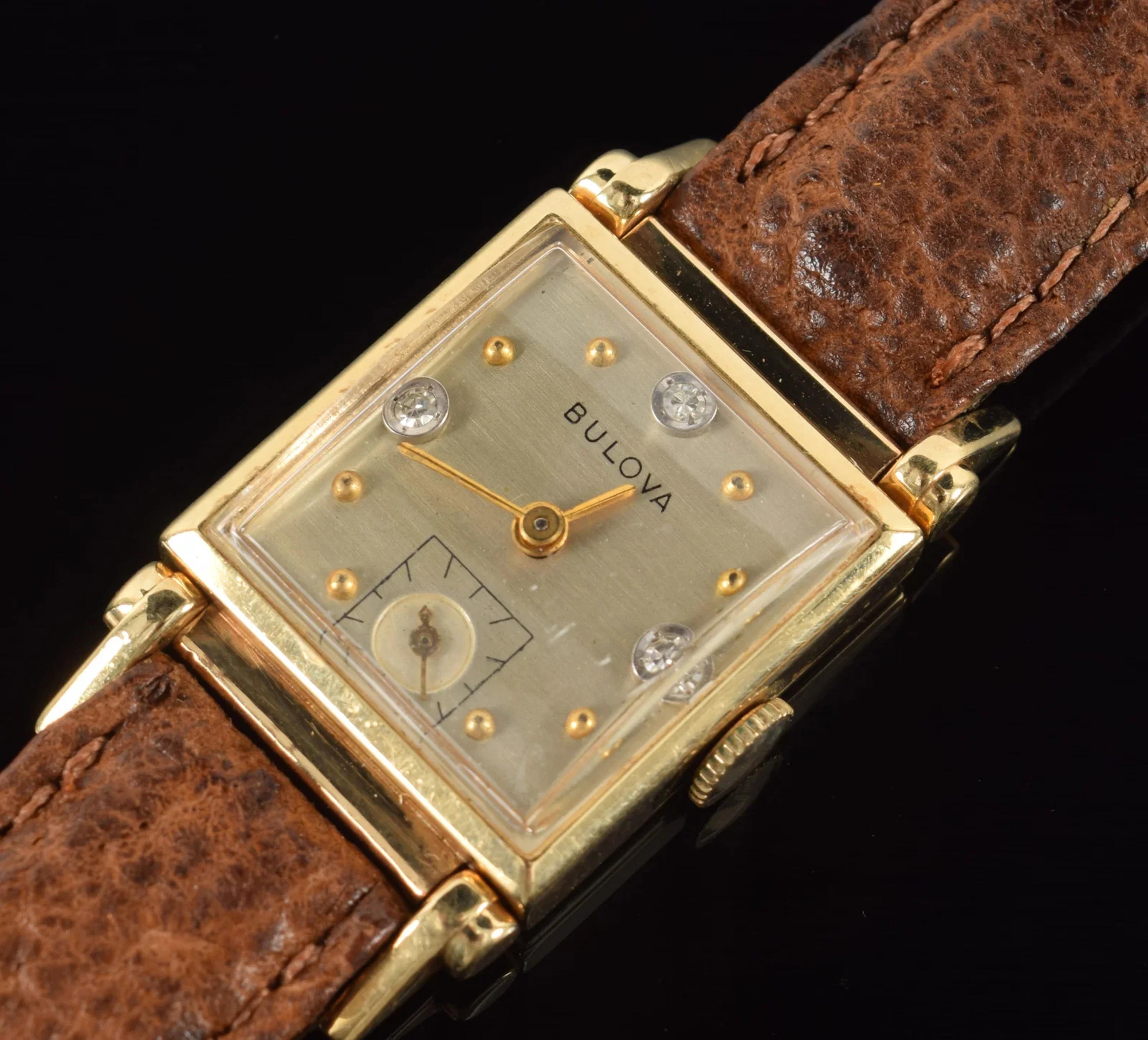 Bulova 14K gold men's tank wristwatch. Face set with 3 round cut diamonds
