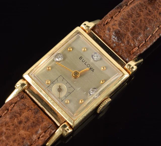 Bulova 14K gold men's tank wristwatch. Face set with 3 round cut diamonds