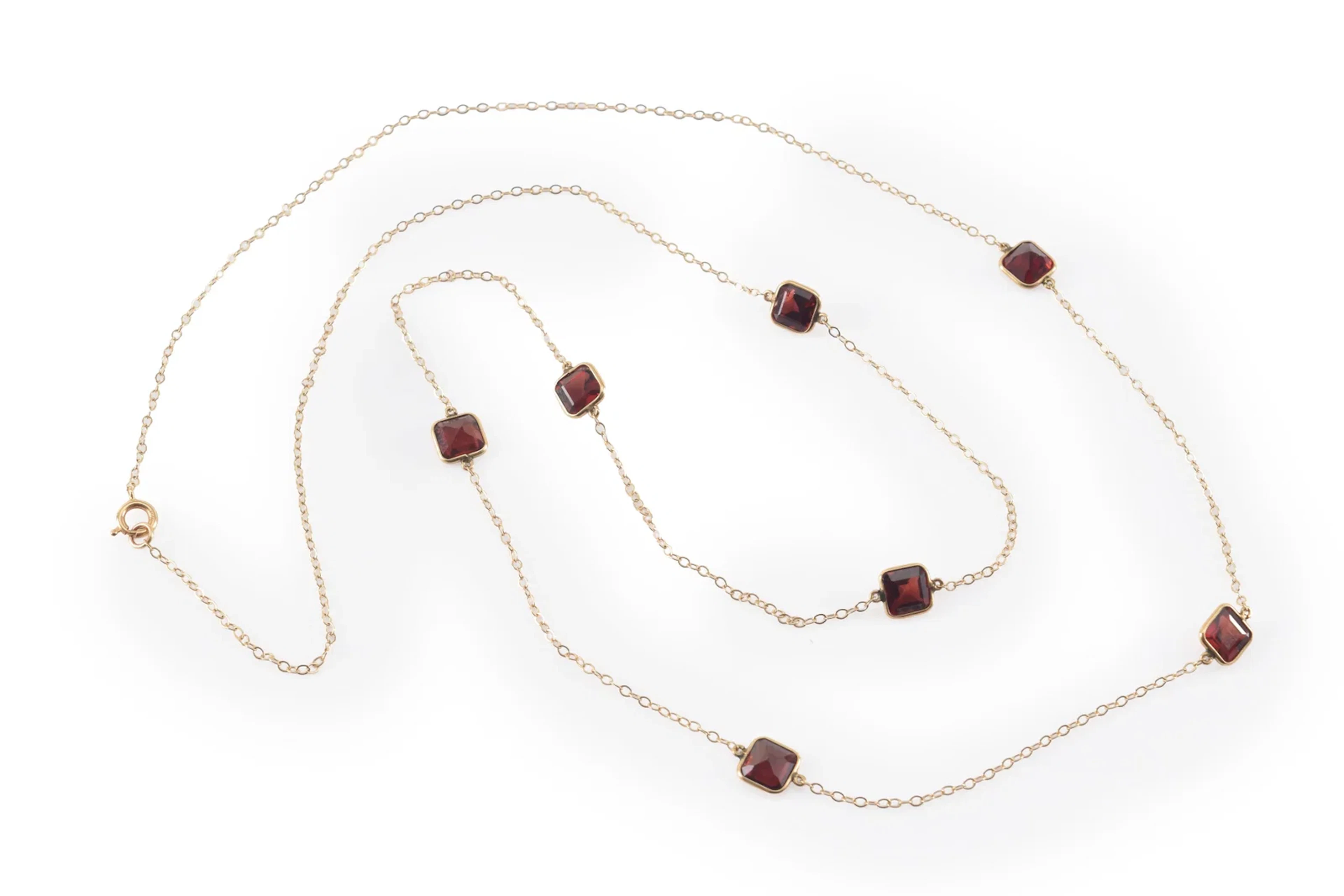 14K gold garnet mounted necklace. Long chain set with 7 square cut
