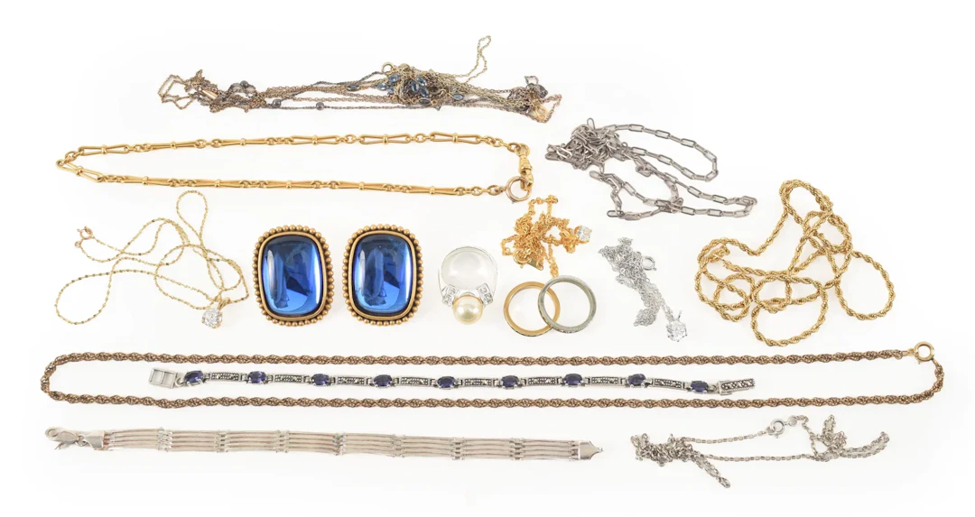 Assorted costume and silver jewelry. To include: Yves St. Laurent