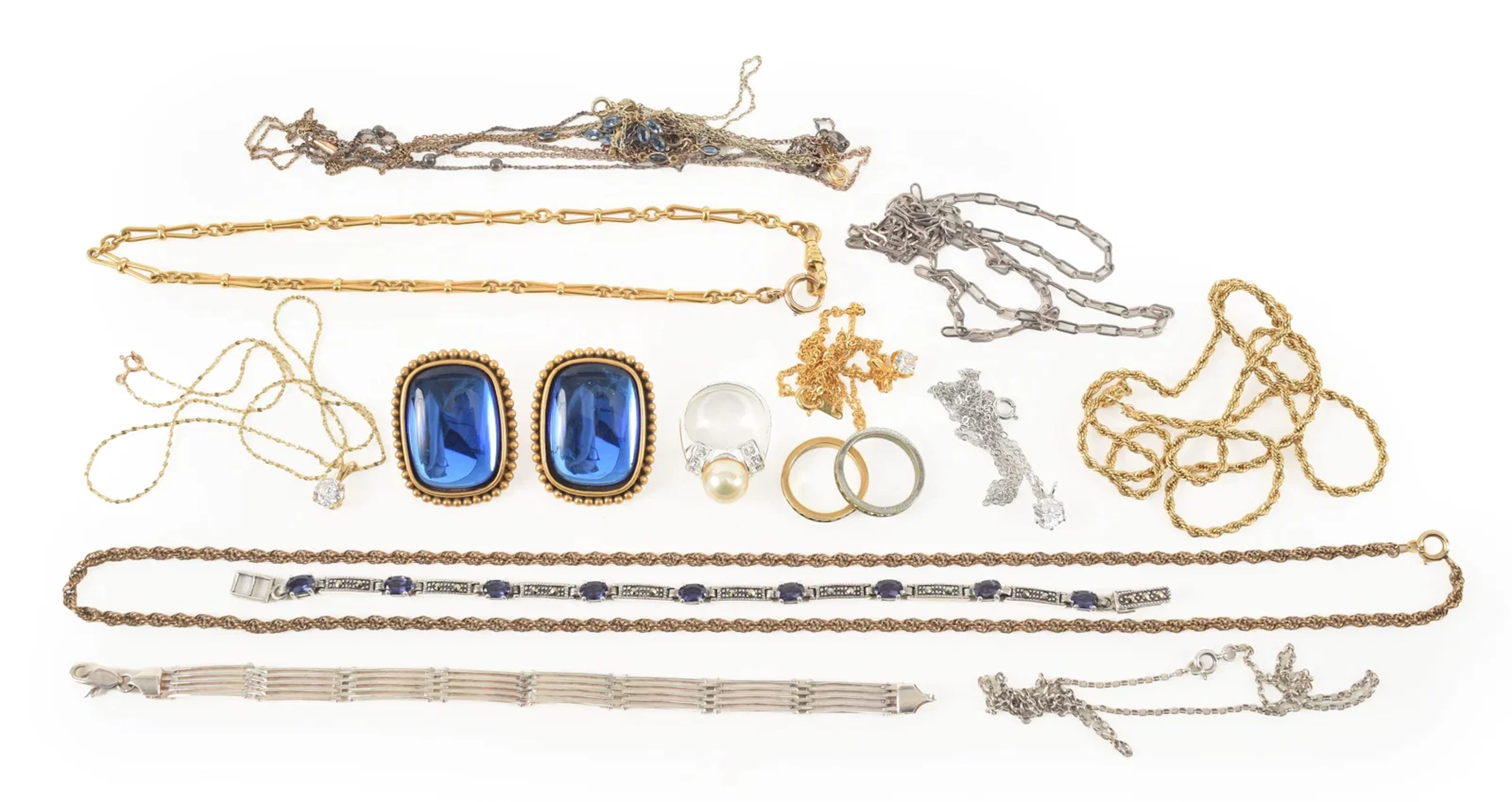 Assorted costume and silver jewelry. To include: Yves St. Laurent