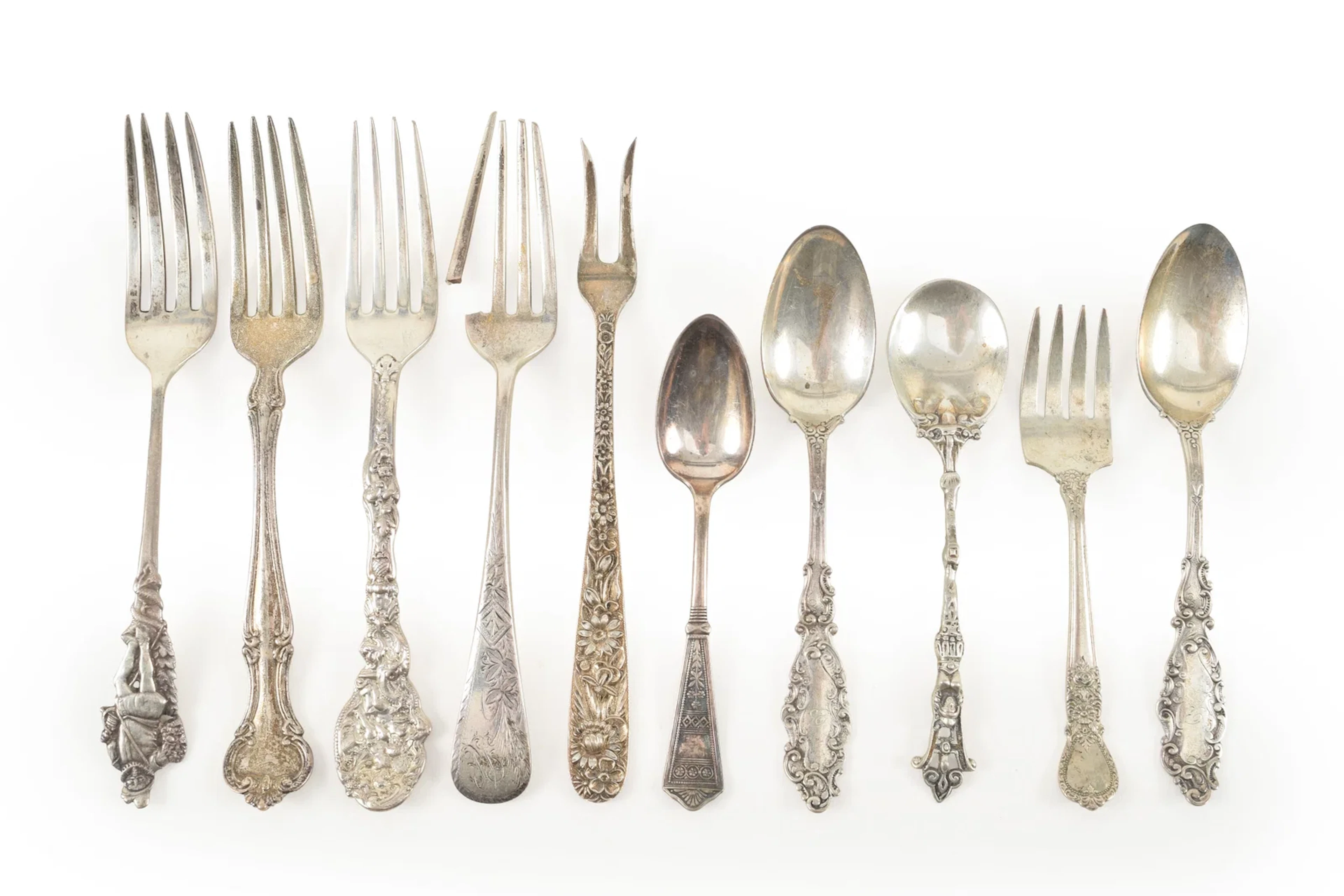 Collection of 10 Silver spoons and forks, some souvenir. Longest 5.75