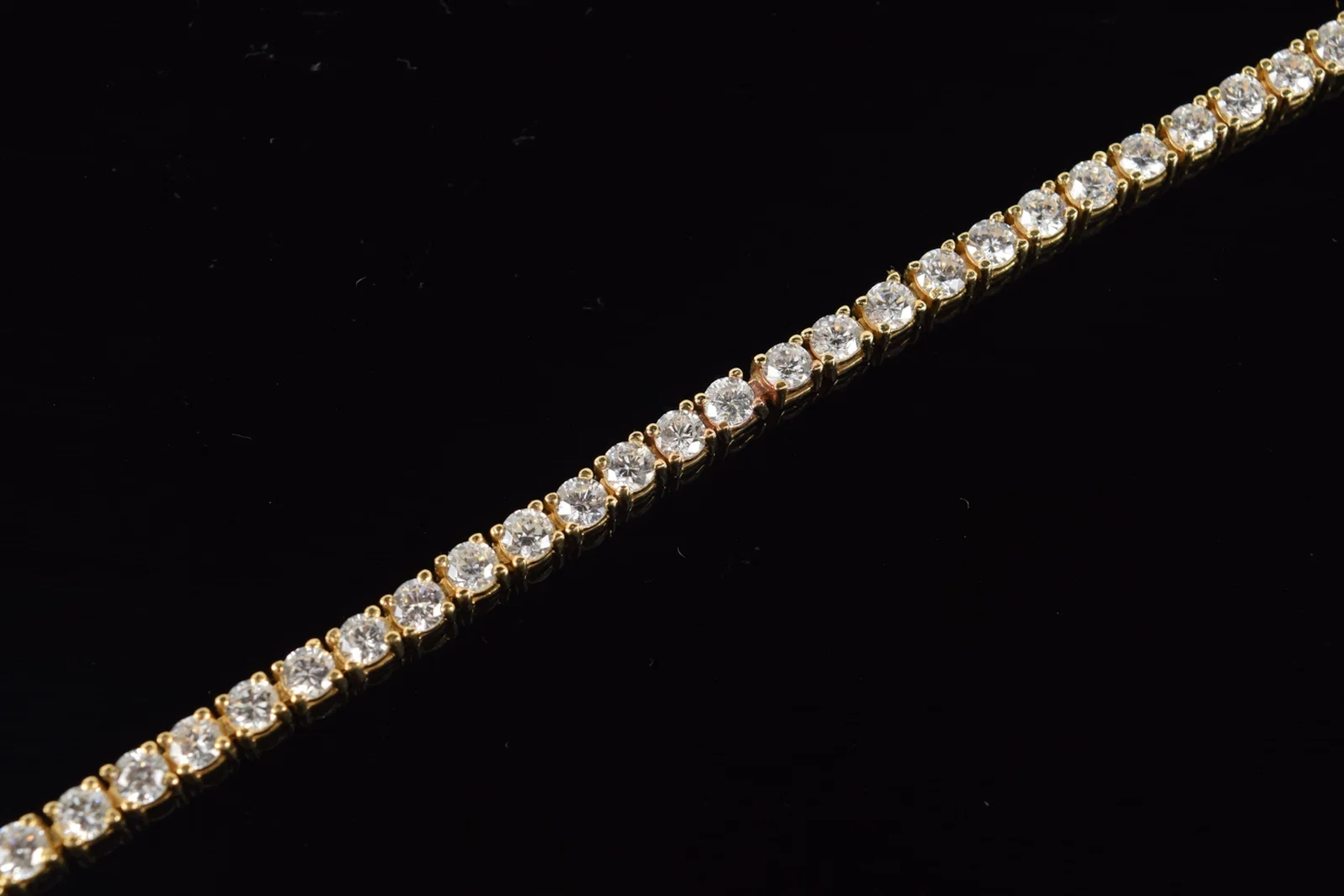 14K gold diamond tennis bracelet. 60 round brilliant cut diamonds