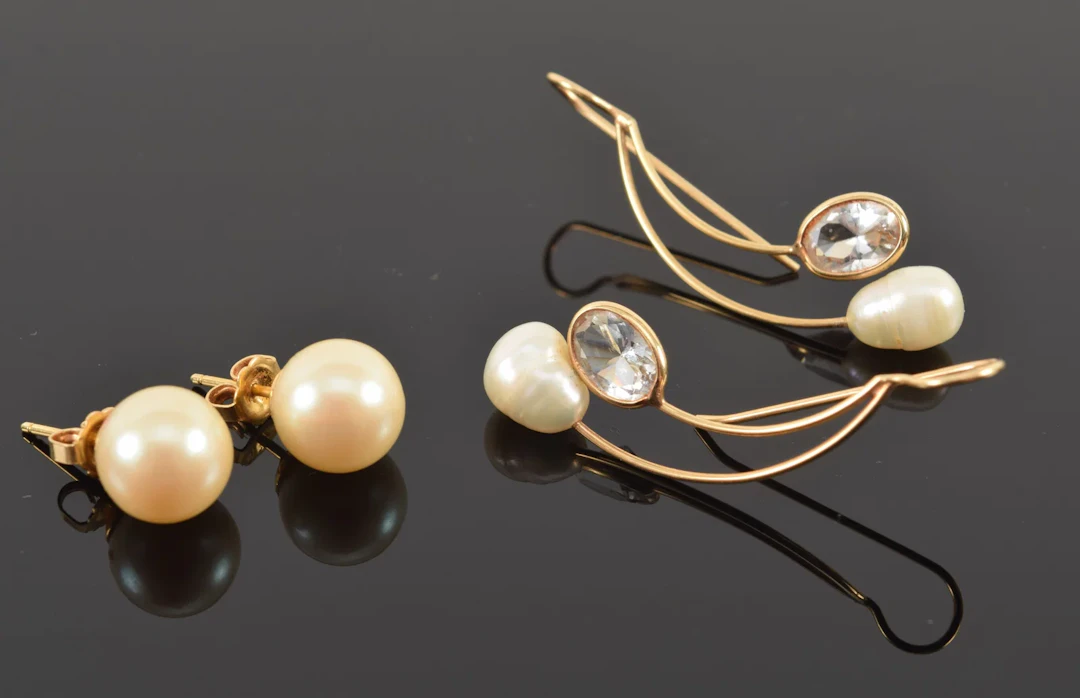 2 pairs of 14K gold pearl earrings. 1) Pearls and oval cut white sapphires.