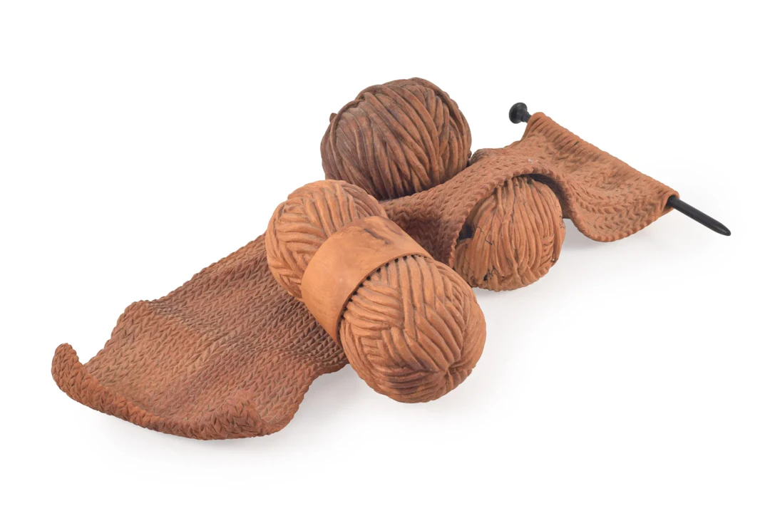 Michelle Holzapfel. "Knitting". Trompe l'oeil wood carving of a knitting