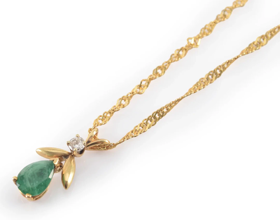 14K gold emerald and diamond pendant necklace. Pear shaped emerald