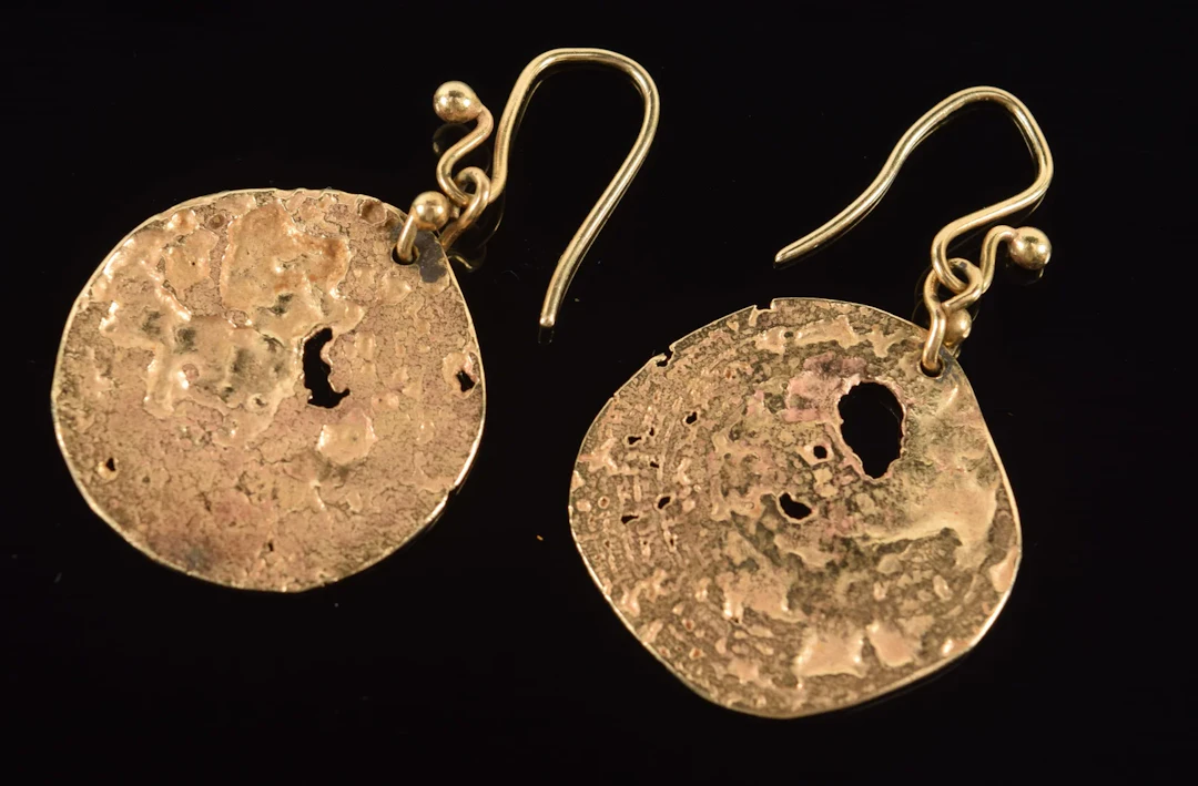 14K gold modern earrings. Thin wafer-like medallions with openings.