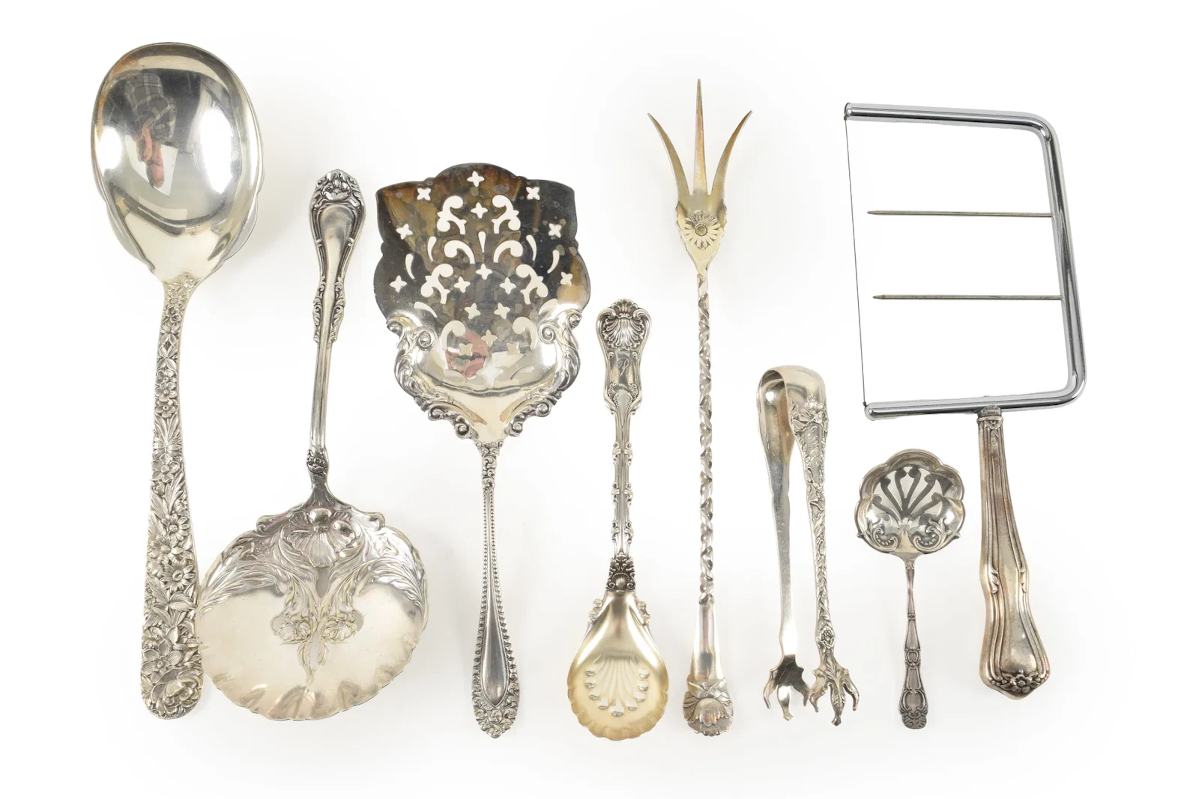 6 Sterling silver serving items including pierced spoons, pickle forks