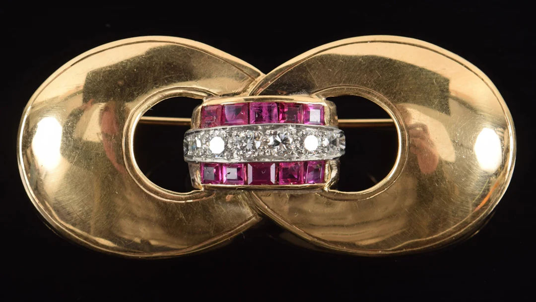 Retro 14K gold diamond and ruby buckle form pin. Central channel of
