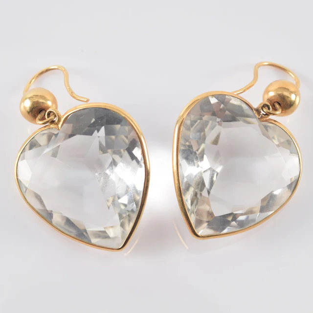 14K gold heart form earrings. Large faceted colorless stone in the