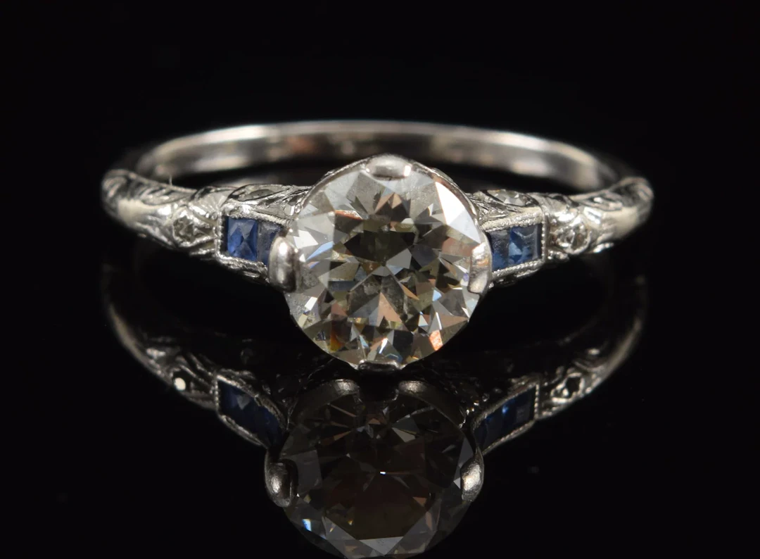 Vintage platinum 1.0CT plus diamond and sapphire ring. Round cut stone