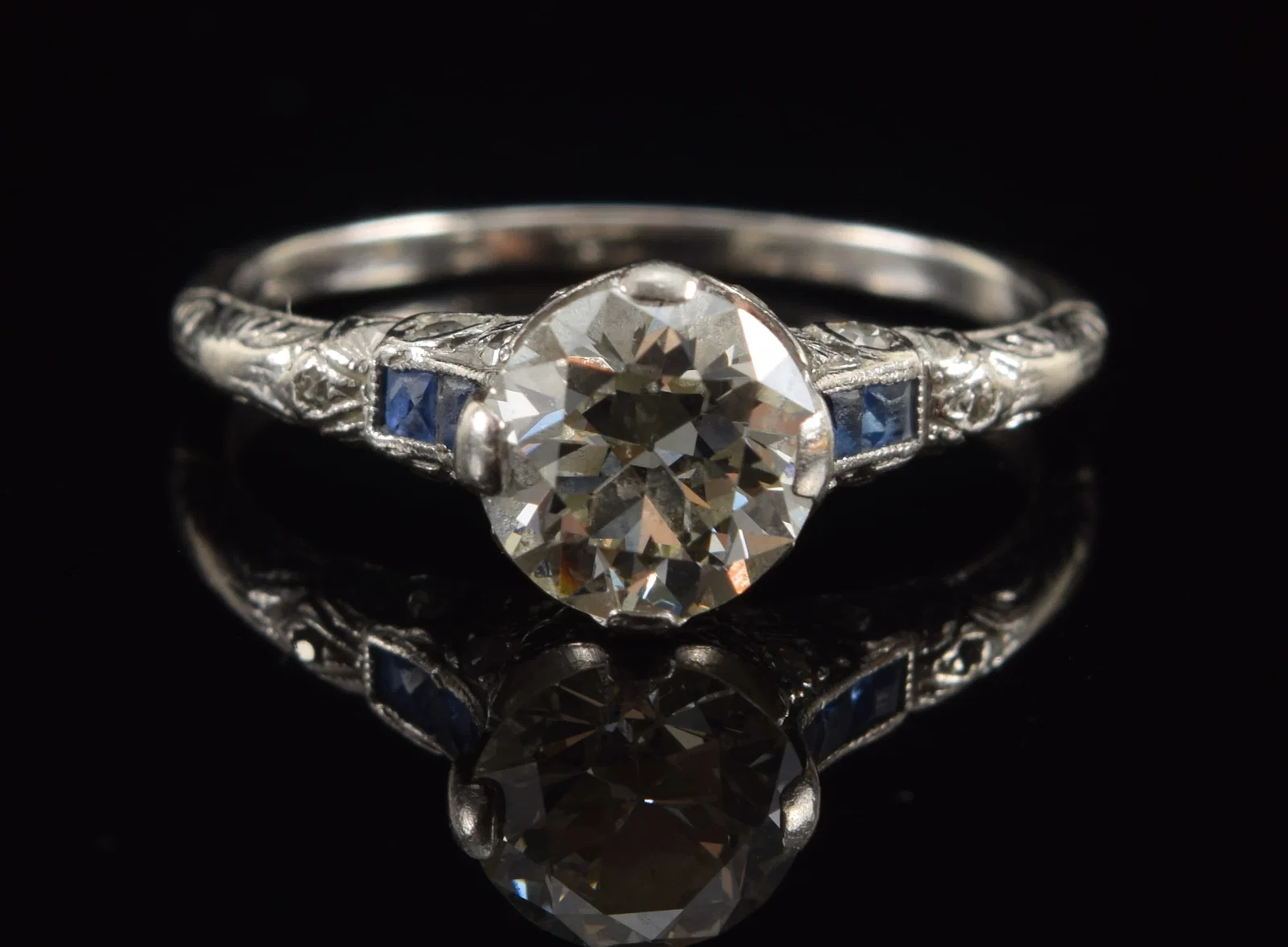 Vintage platinum 1.0CT plus diamond and sapphire ring. Round cut stone