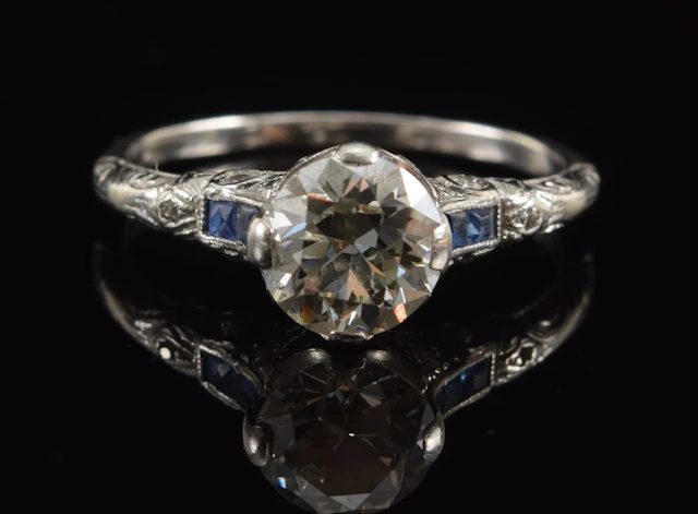 Vintage platinum 1.0CT plus diamond and sapphire ring. Round cut stone