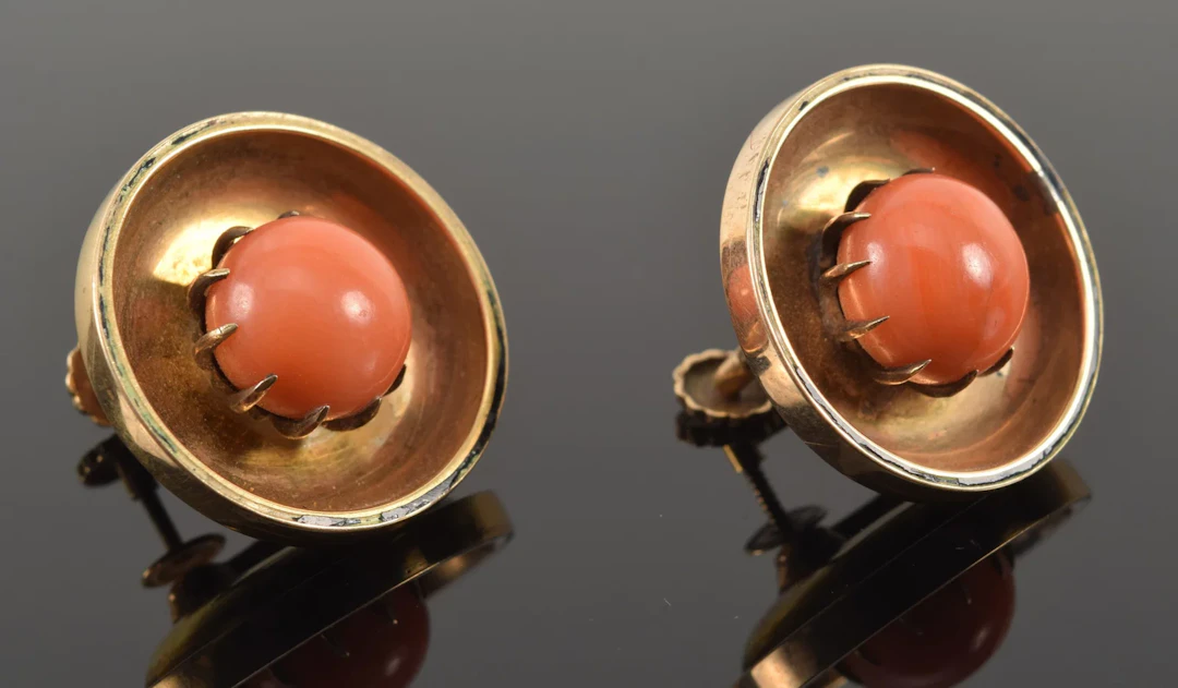 Antique 10K gold coral mounted earrings. Round, recessed form. Screwbacks