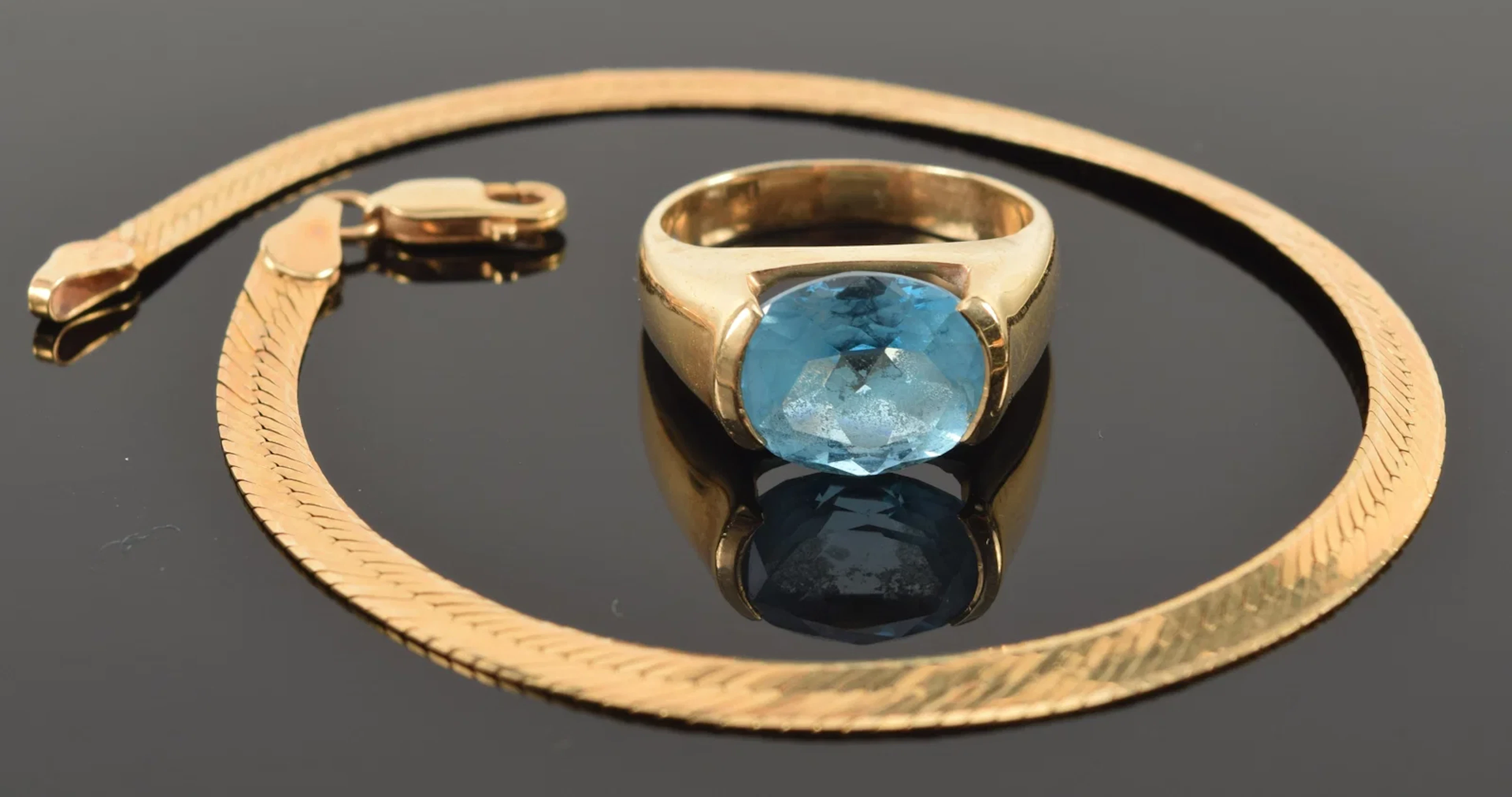 2 pieces of 14K gold jewelry. 1) Blue topaz ring. Stone measures 9.9